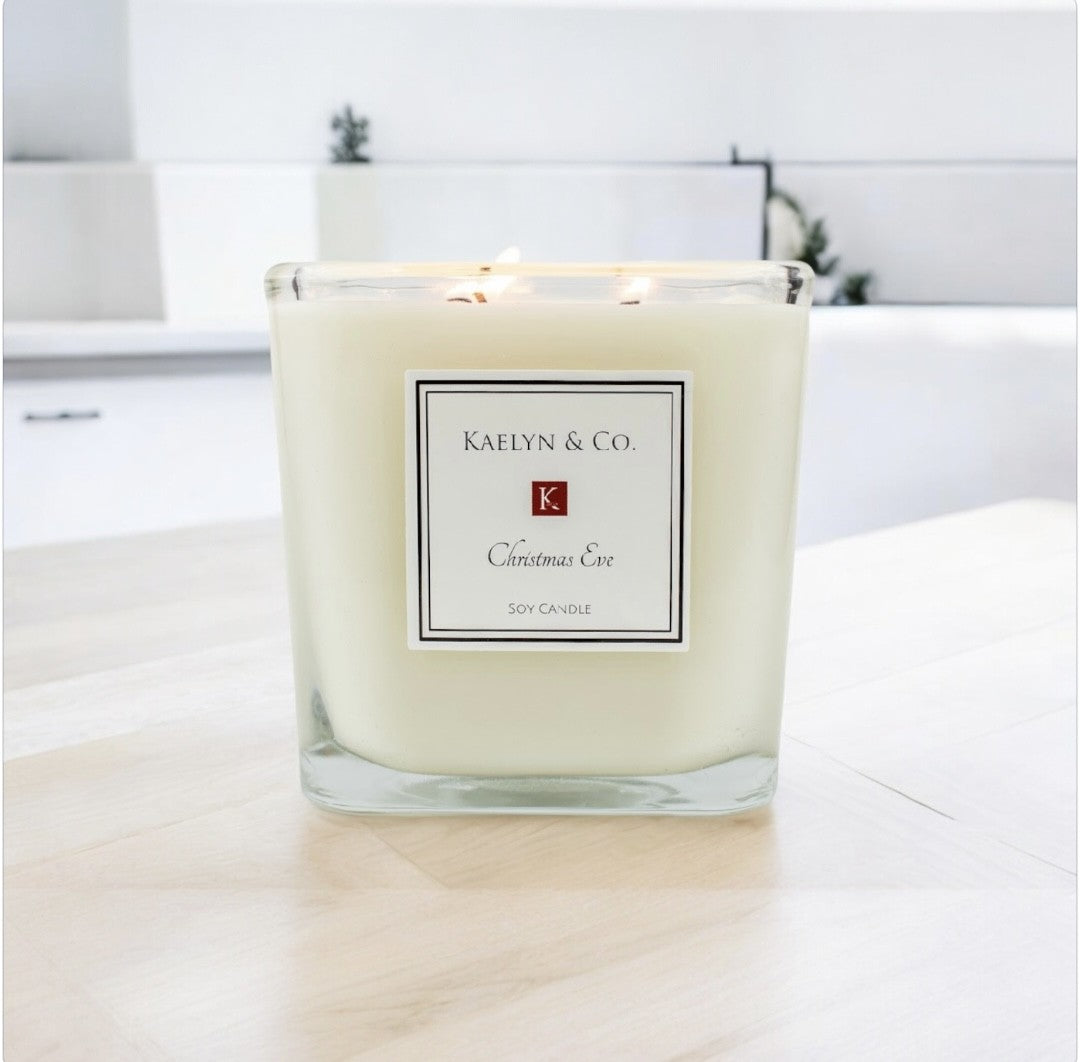 A large cube candle with a festive Christmas Eve scent, featuring a warm glow and a cozy holiday ambiance.