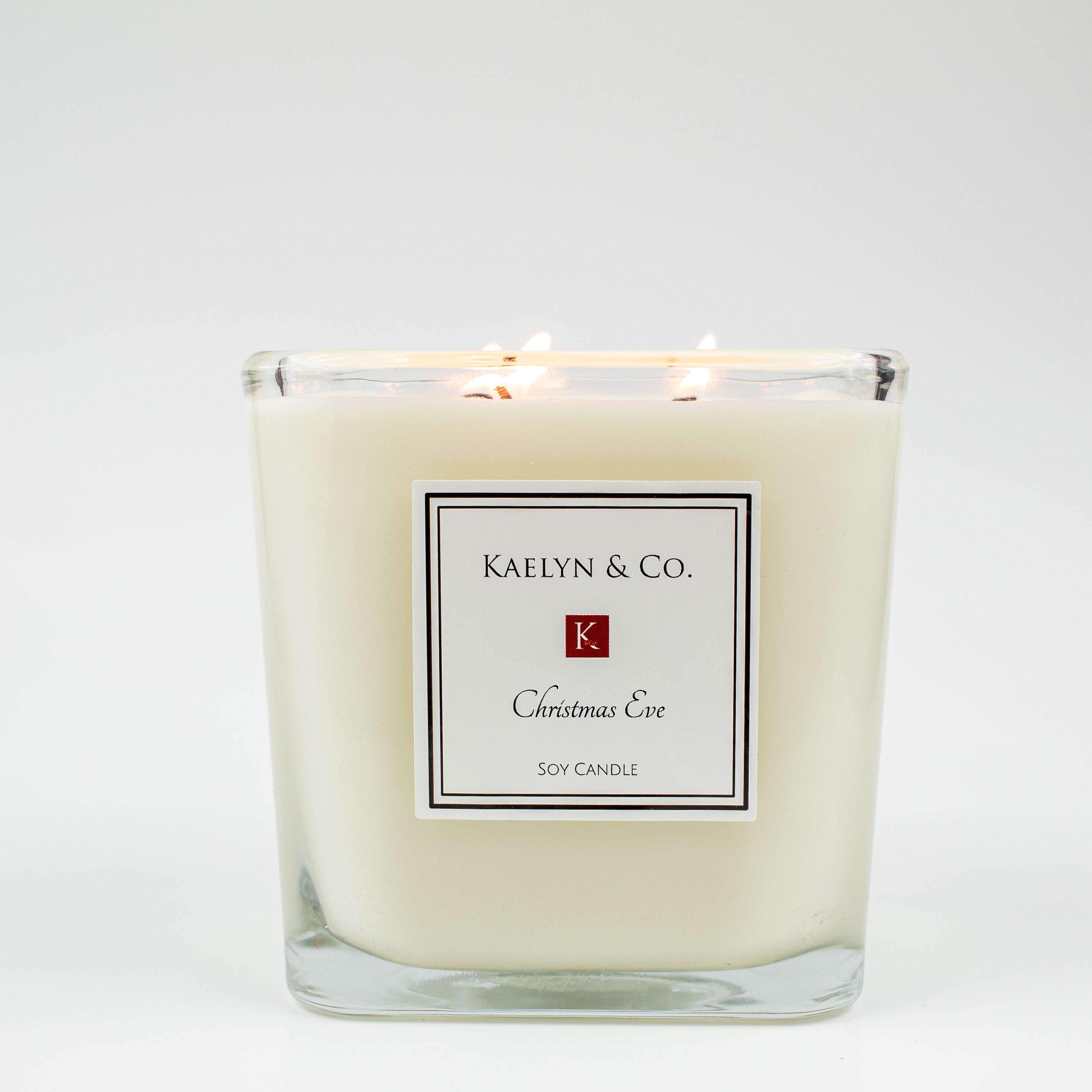 A large cube candle with a festive Christmas Eve scent, featuring a warm glow and a cozy holiday ambiance.