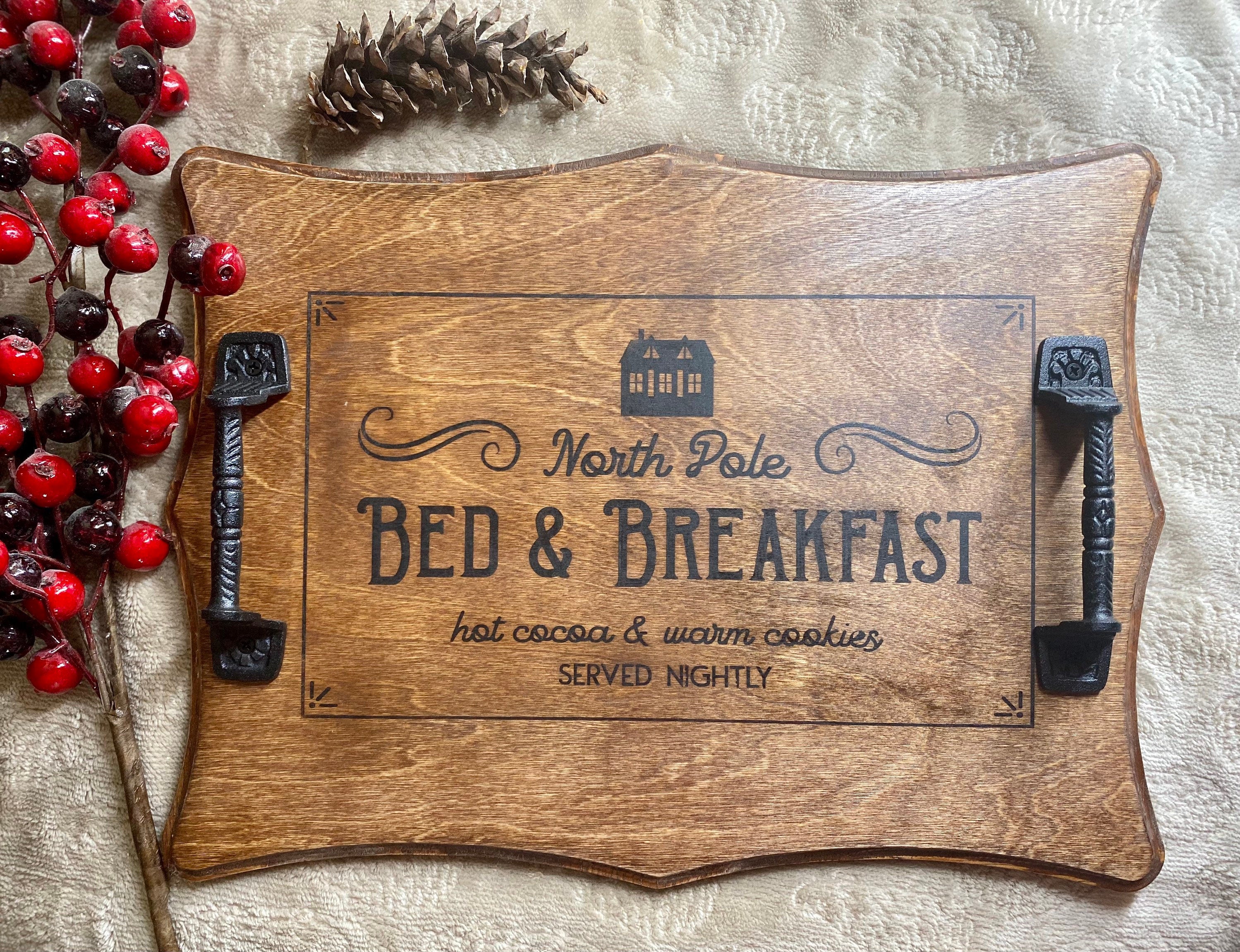 Handmade Christmas serving tray made of birch plywood with a rich chestnut stain, featuring black metal handles and unique wood grain patterns.