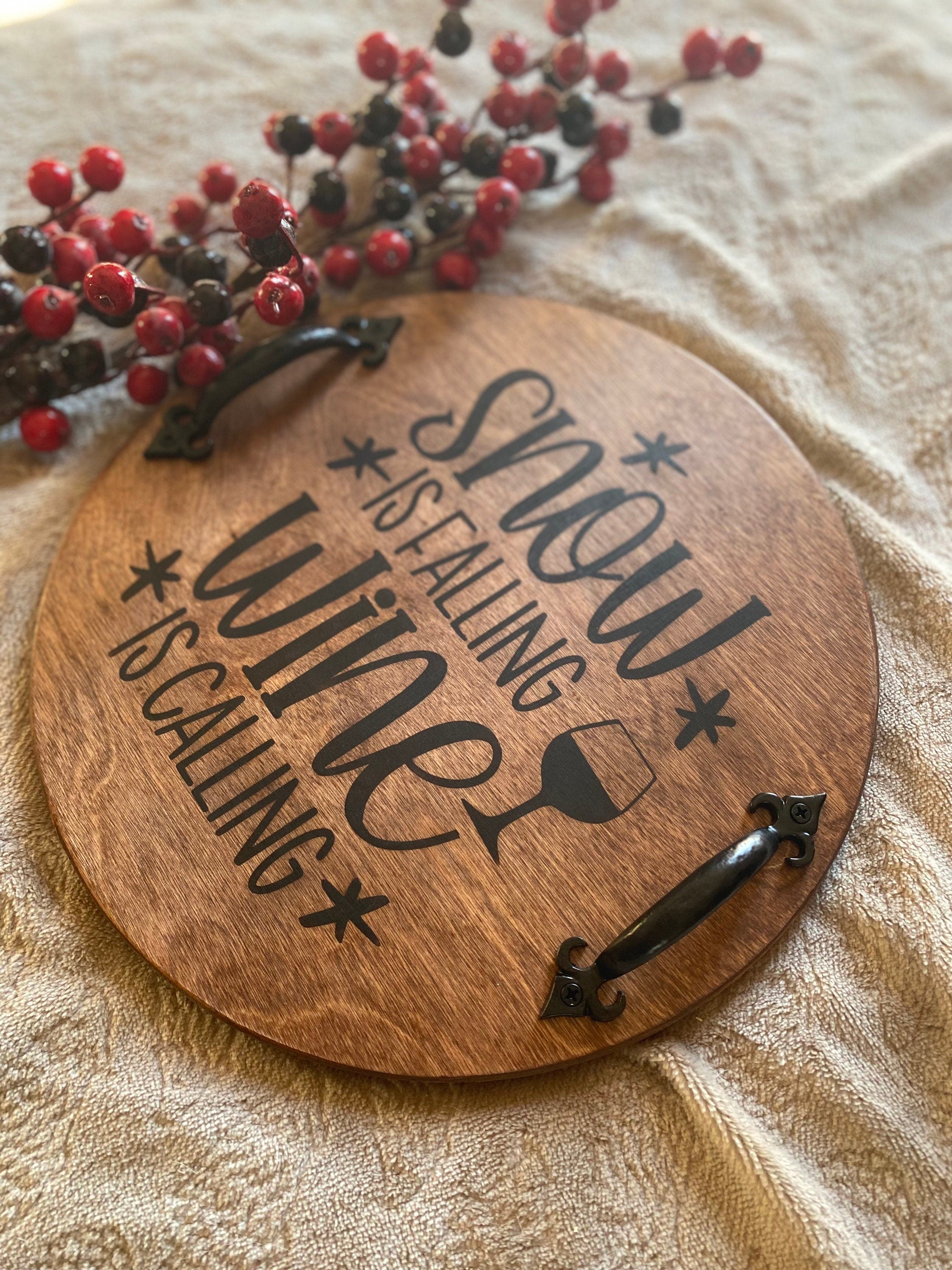 Handmade rustic Christmas serving tray made of birch plywood with a rich chestnut stain and black metal handles, showcasing unique wood grain patterns.