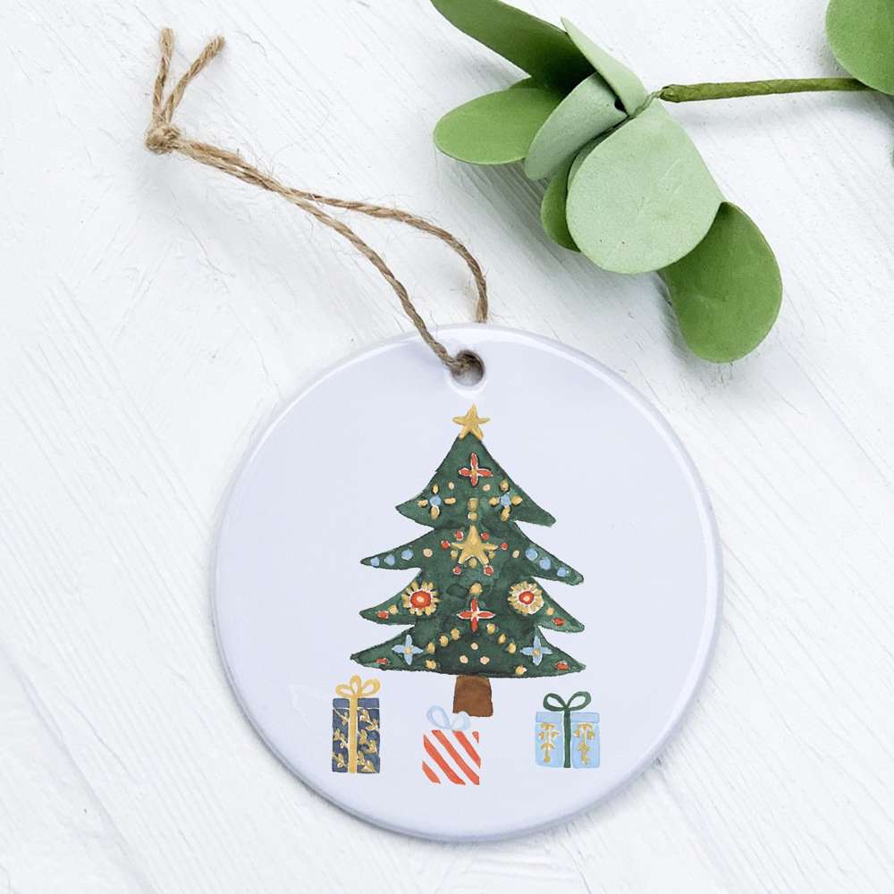 A beautifully crafted porcelain Christmas ornament featuring a tree and gifts design, perfect for holiday decor.