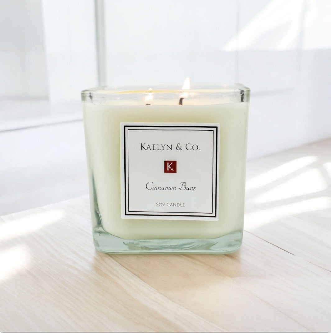 Cinnamon Buns Medium Cube Candle in decorative box, showcasing its warm, inviting scent and elegant design.