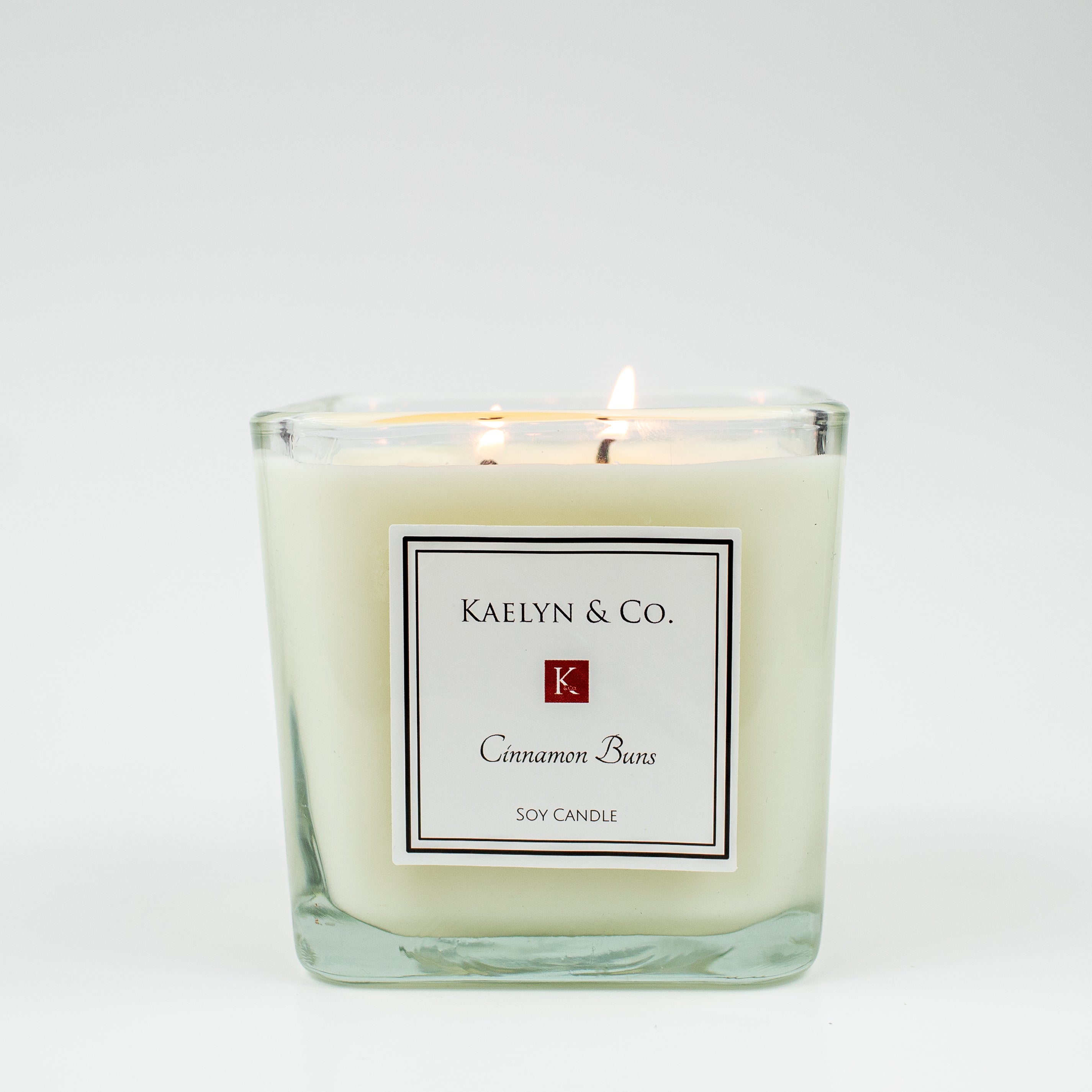 Cinnamon Buns Medium Cube Candle in decorative box, showcasing its warm, inviting scent and elegant design.