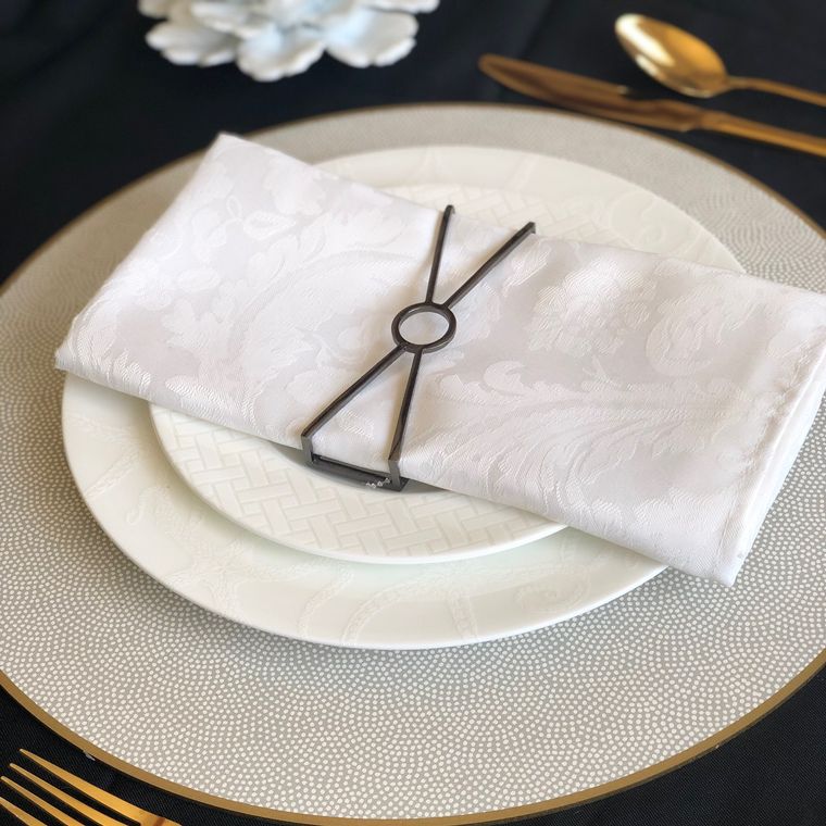 Circle X Napkin Wrap in Matte Charcoal, featuring a sleek and modern design perfect for elegant table settings.