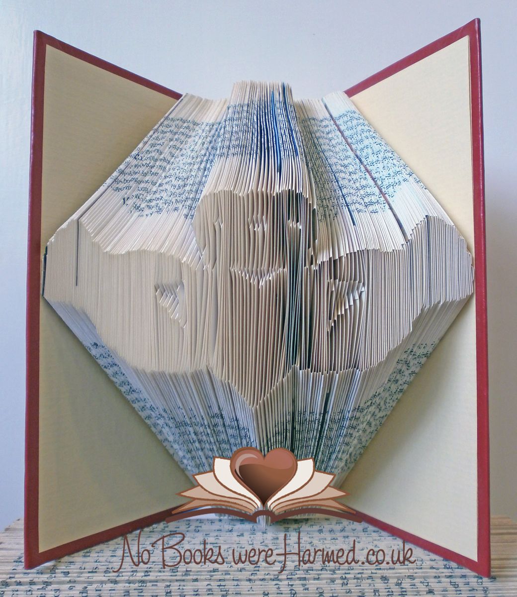 Handcrafted Claddagh art piece made from vintage book pages, showcasing unique colors and intricate folds.