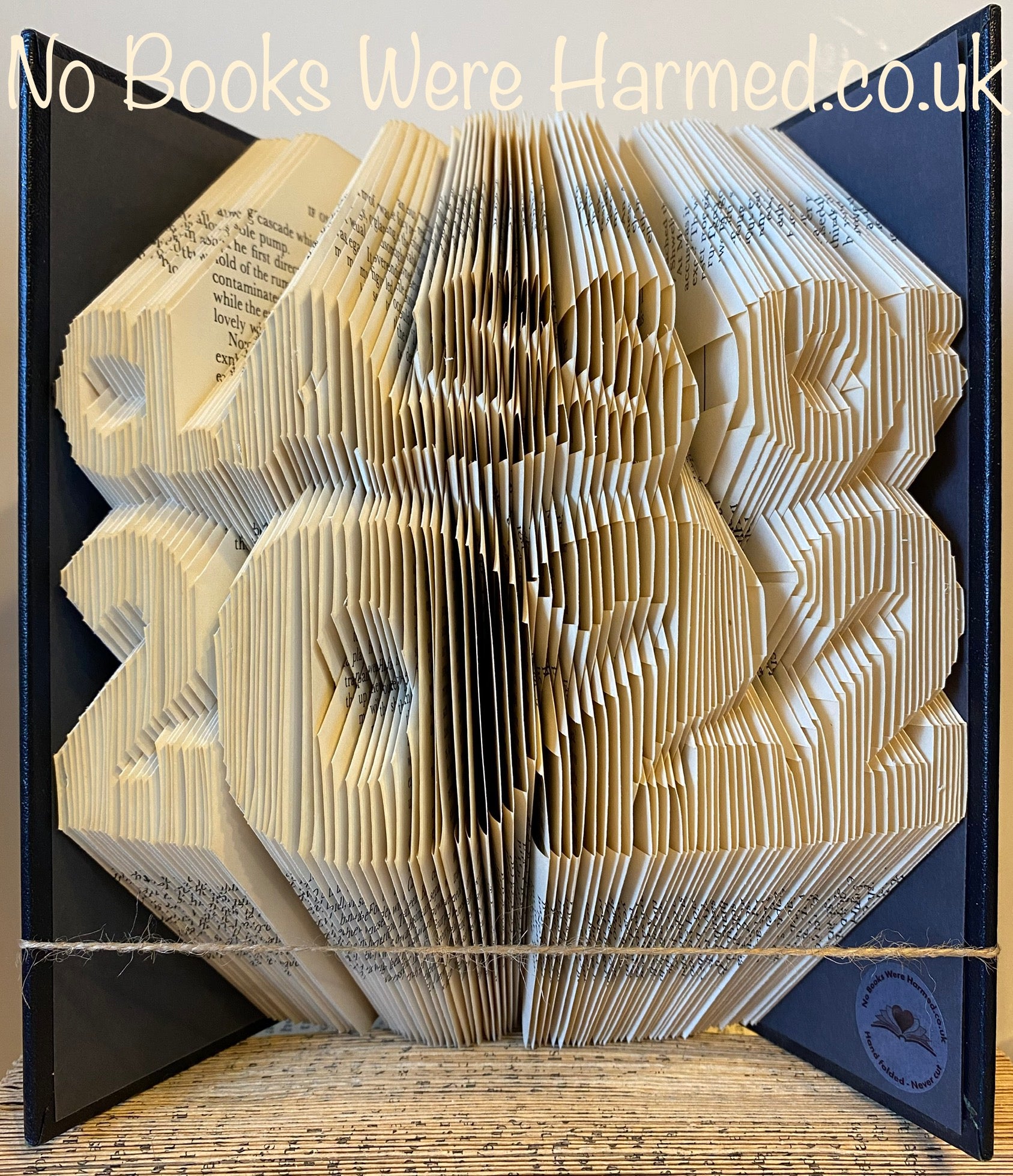 Hand folded book art celebrating the Class of 2022, crafted from vintage books with unique designs.