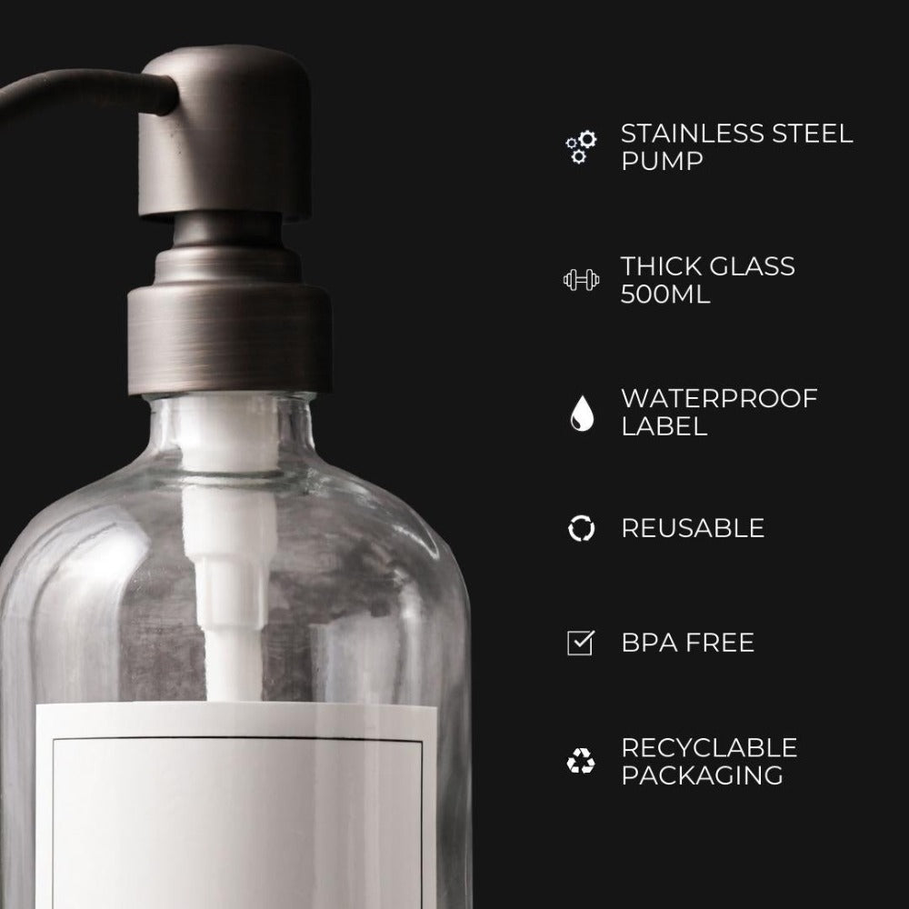 Set of three clear glass bathroom soap dispensers with matte black stainless steel pumps, ideal for shampoo and body wash.