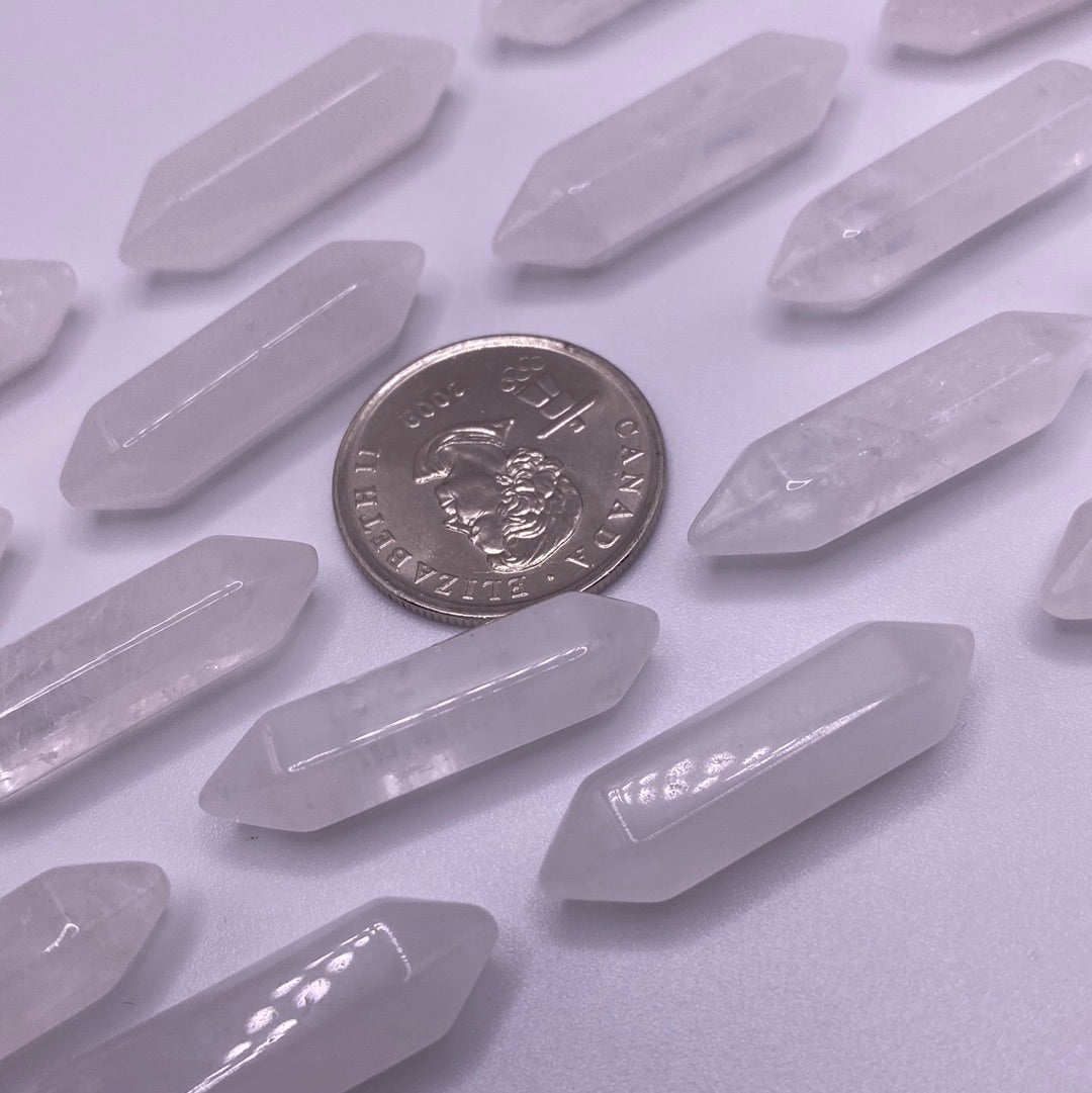 A small double terminated Clear Quartz point with a shiny, transparent appearance, showcasing its natural beauty and energy amplification properties.