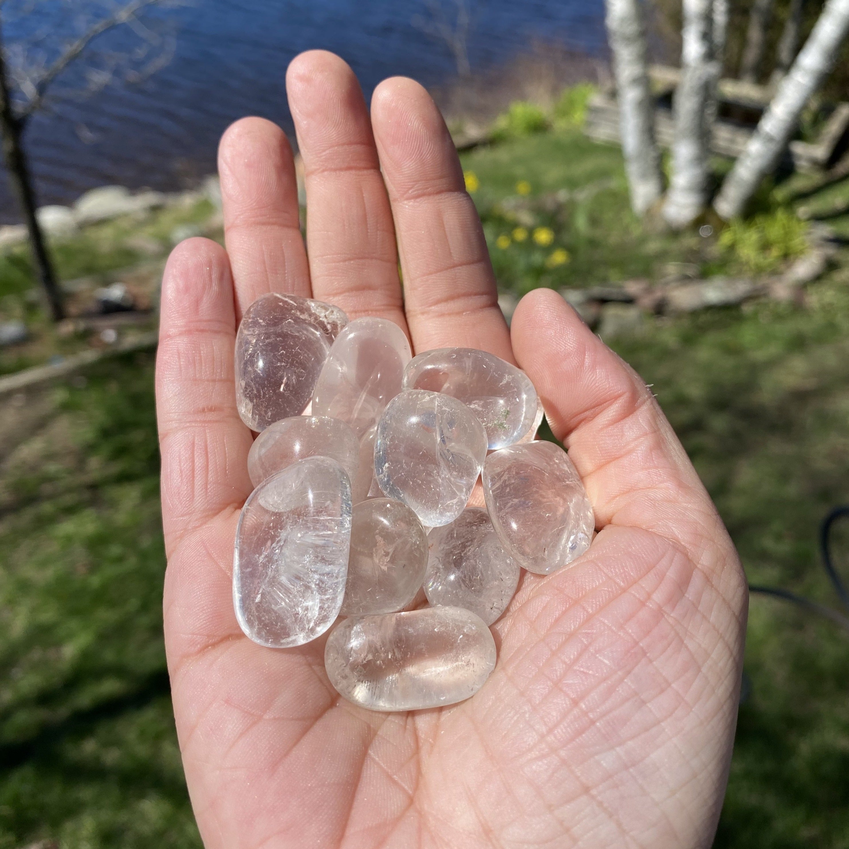 A collection of Clear Quartz Tumbled Crystal Stones, showcasing their unique shapes and smooth surfaces, perfect for healing and meditation.