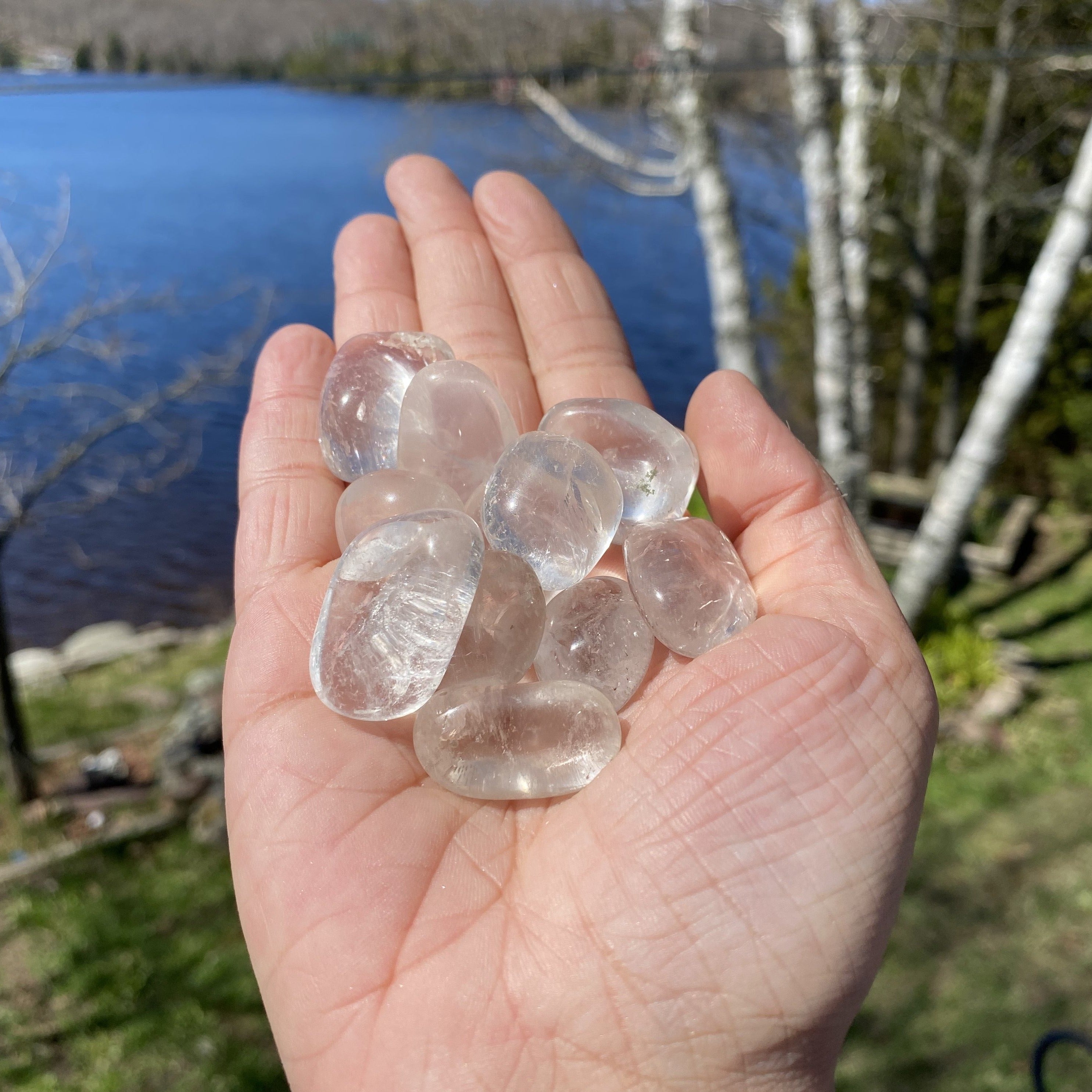 A collection of Clear Quartz Tumbled Crystal Stones, showcasing their unique shapes and smooth surfaces, perfect for healing and meditation.