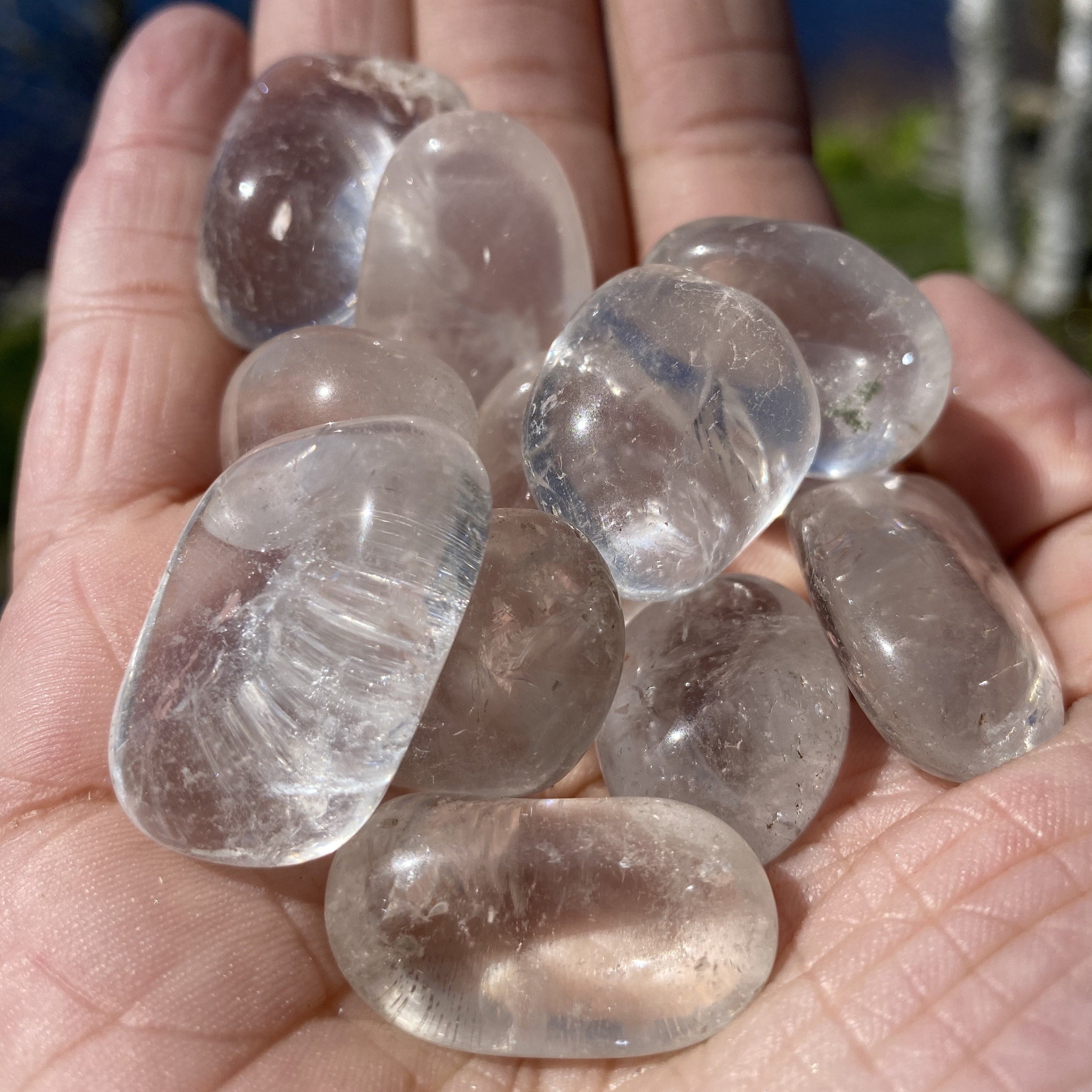 A collection of Clear Quartz Tumbled Crystal Stones, showcasing their unique shapes and smooth surfaces, perfect for healing and meditation.