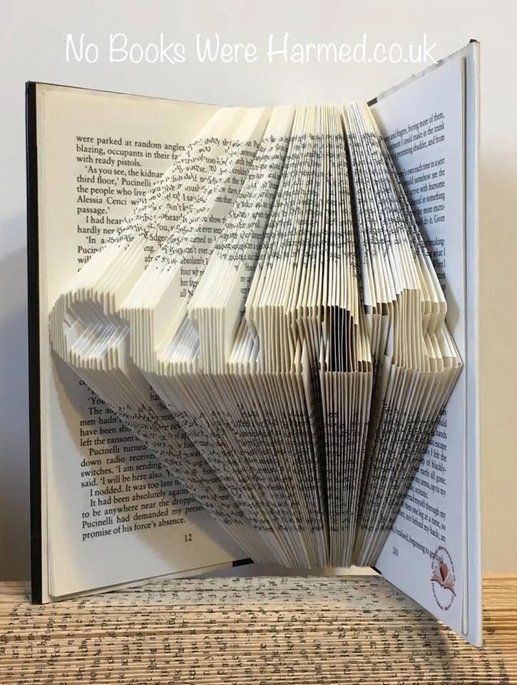 A beautifully crafted piece of book art made from vintage pages, showcasing intricate hand-folded designs.