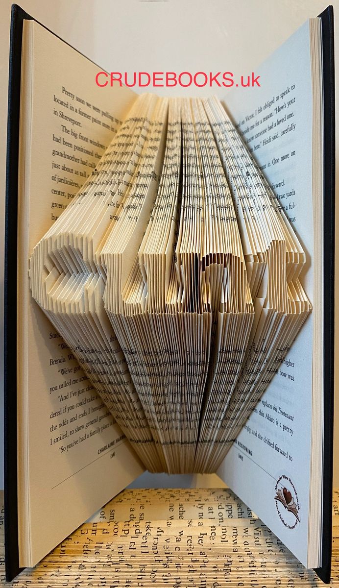 A beautifully crafted piece of book art made from vintage pages, showcasing intricate hand-folded designs.