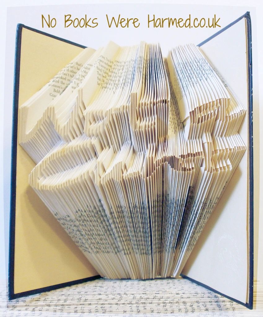 A collection of unique hand-folded book art pieces made from vintage books, showcasing intricate designs and textures.