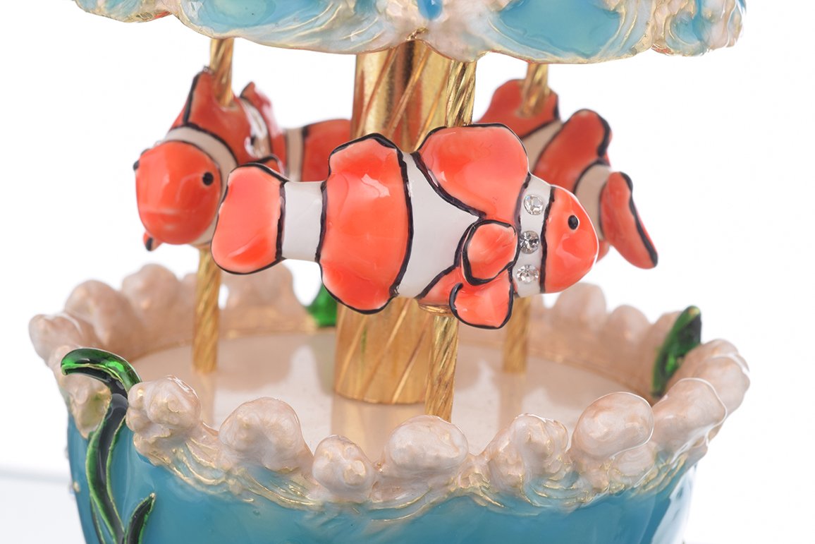 Clownfish Musical Carousel trinket box with Austrian crystals and gold plating, showcasing intricate enamel work and a secure magnetic closure.