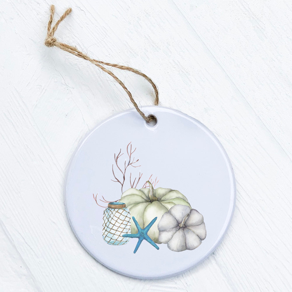 A beautifully crafted Coastal Pumpkins ornament made of high-quality porcelain, featuring vibrant pumpkin designs, perfect for holiday decor.