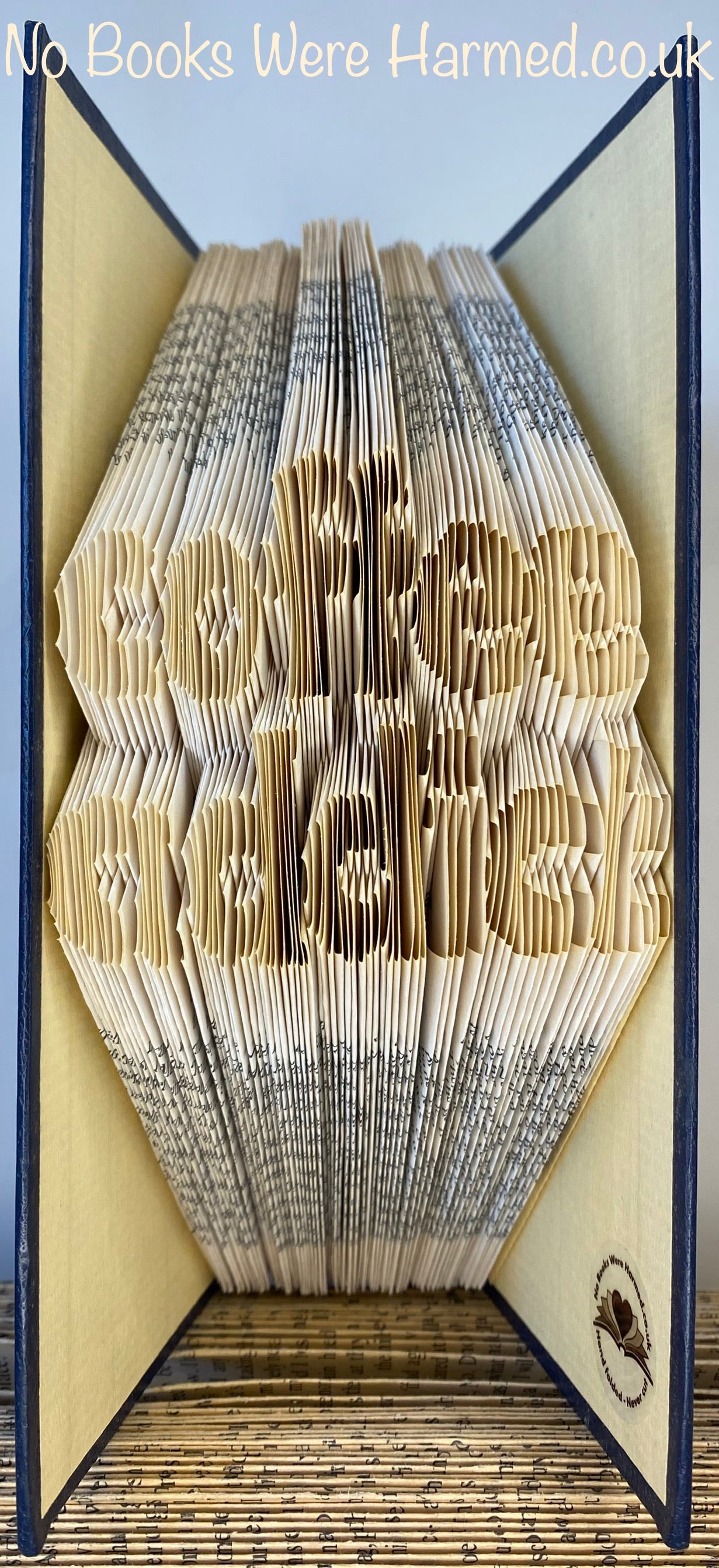Handcrafted coffee-themed book art made from vintage pages, showcasing intricate folds and unique design.