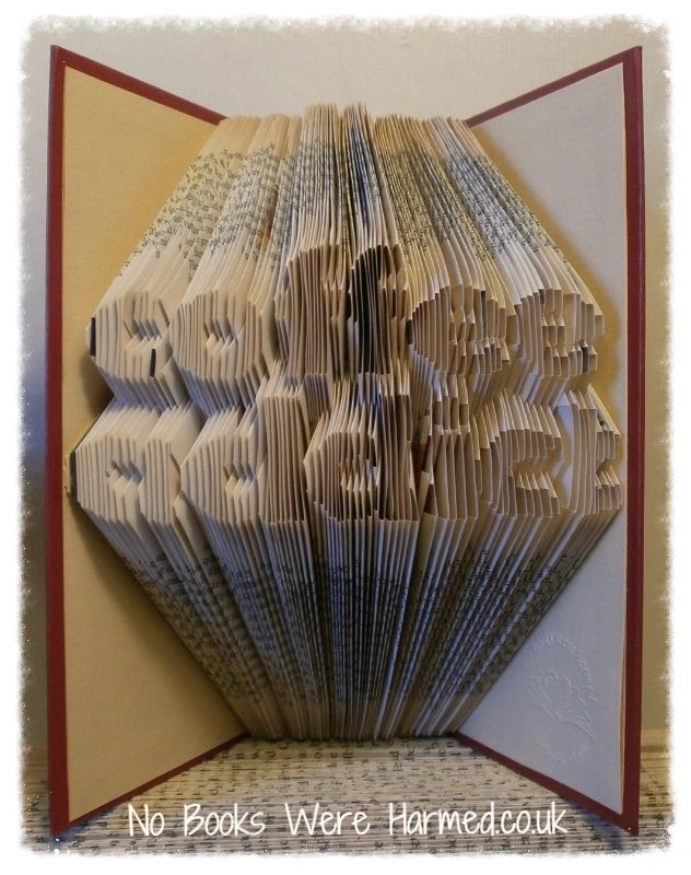 Handcrafted coffee-themed book art made from vintage pages, showcasing intricate folds and unique design.