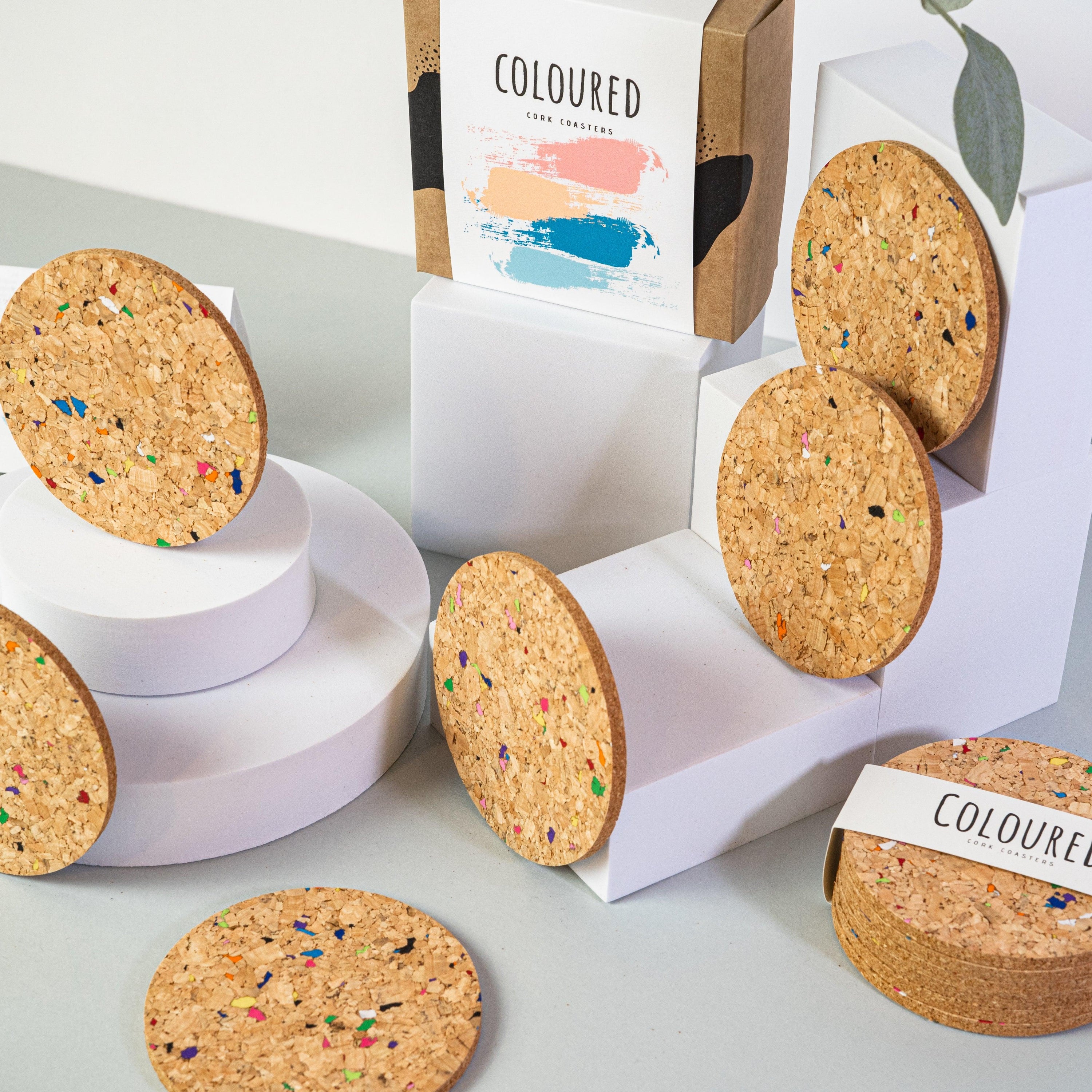 Set of 6 round coloured cork coasters with vibrant patterns, perfect for home decor and protecting surfaces.