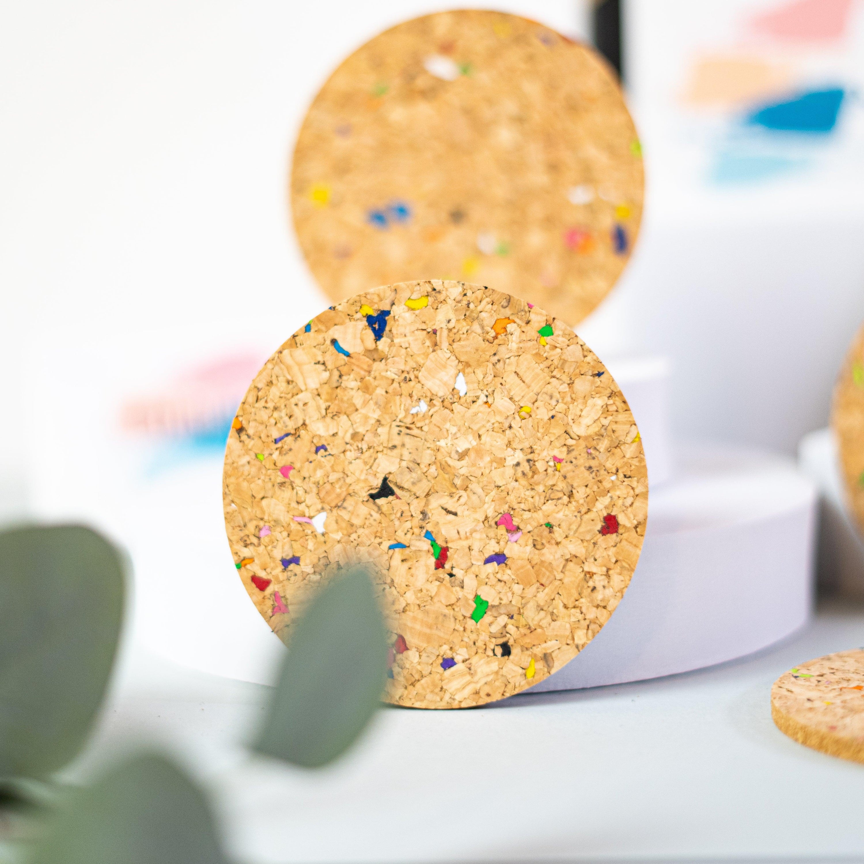 Set of 6 round coloured cork coasters with vibrant patterns, perfect for home decor and protecting surfaces.
