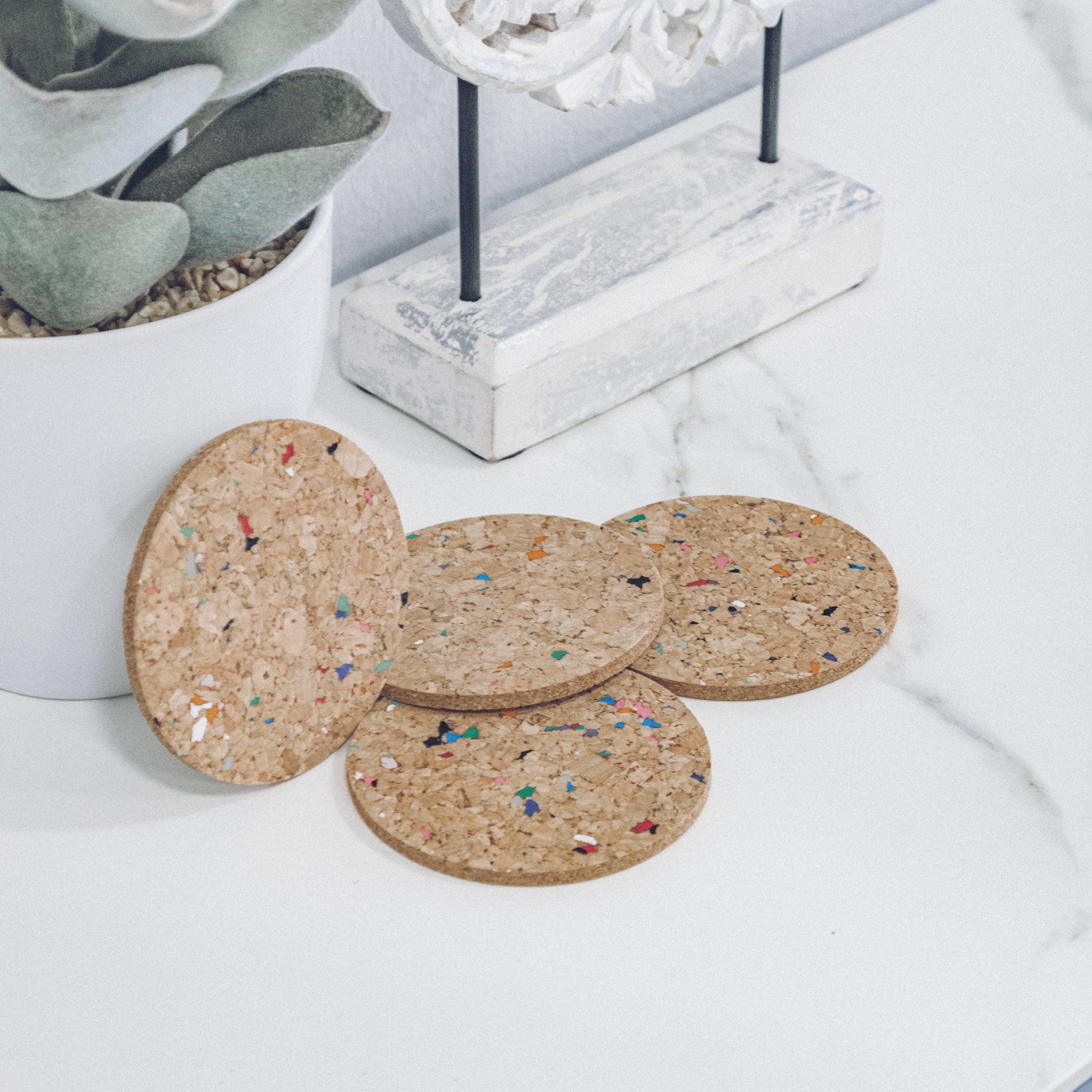 Set of 6 round coloured cork coasters with vibrant patterns, perfect for home decor and protecting surfaces.
