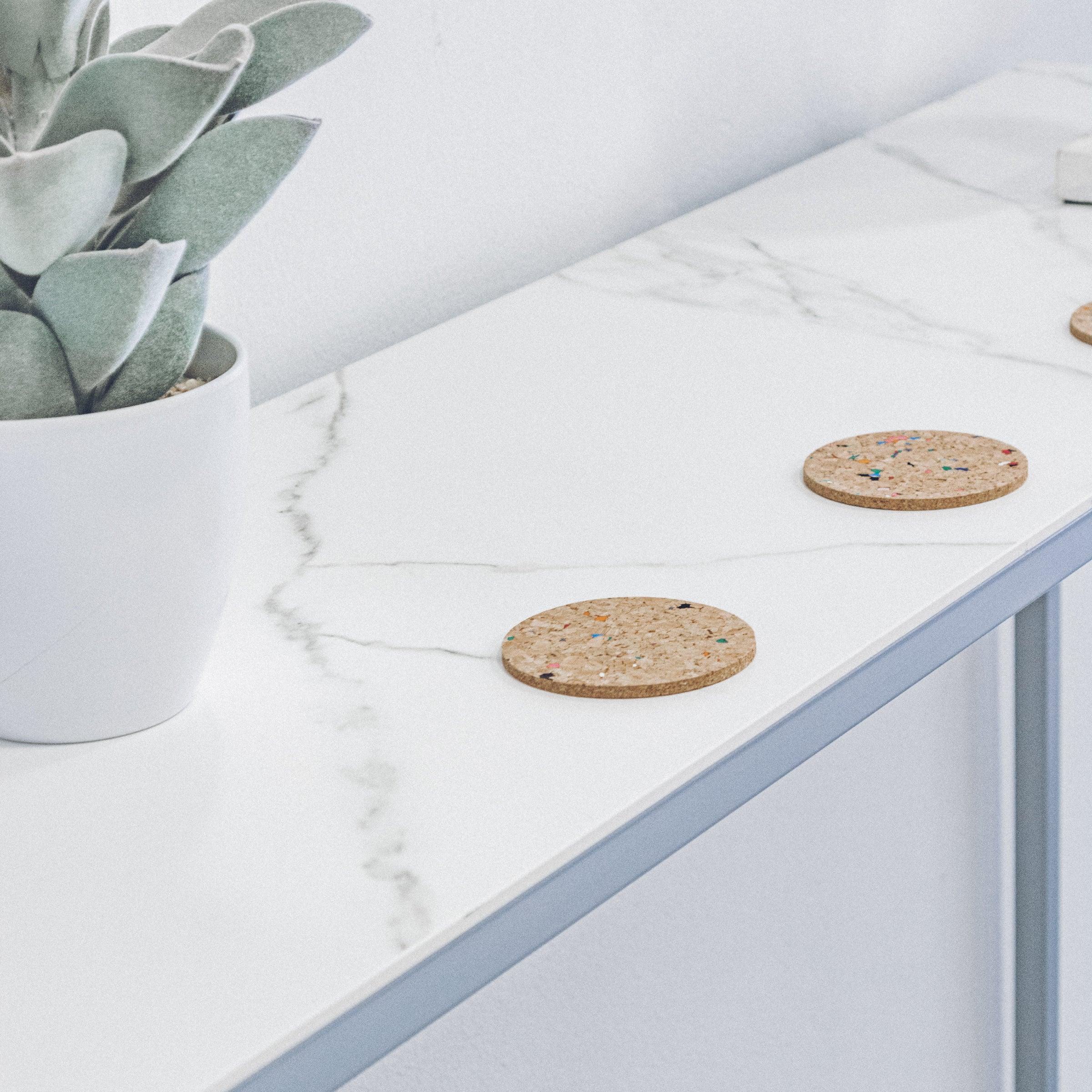 Set of 6 round coloured cork coasters with vibrant patterns, perfect for home decor and protecting surfaces.