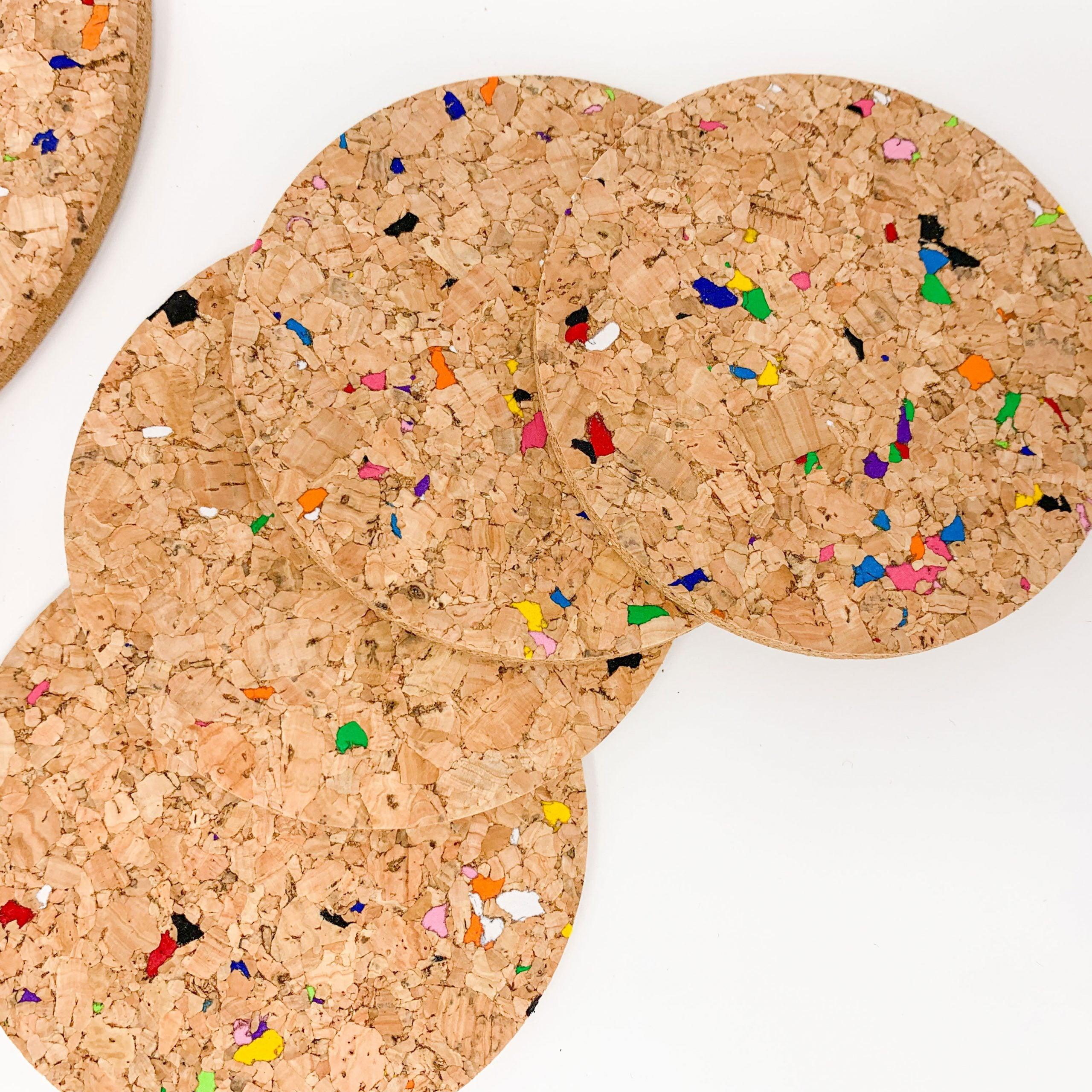 Set of 6 round coloured cork coasters with vibrant patterns, perfect for home decor and protecting surfaces.