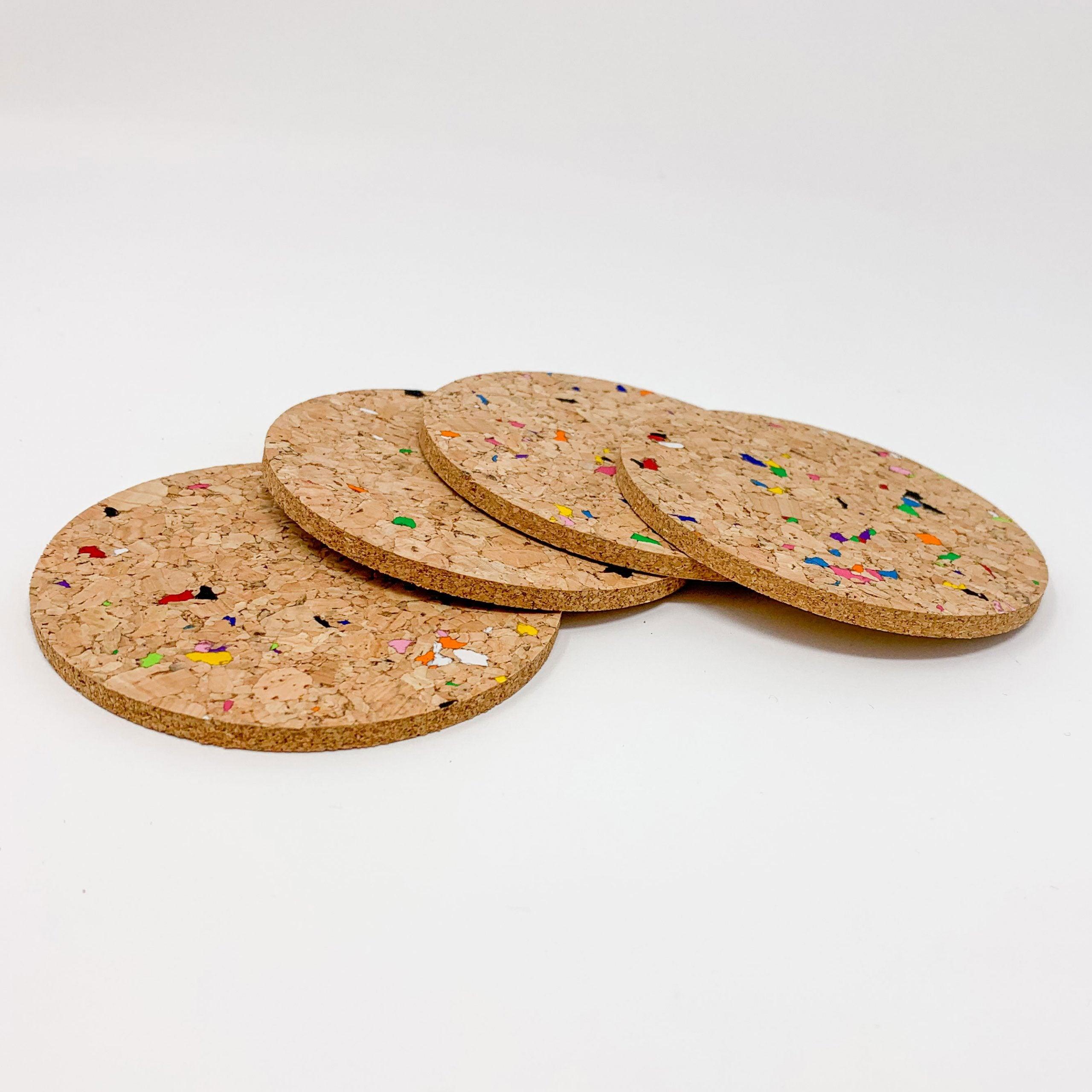 Set of 6 round coloured cork coasters with vibrant patterns, perfect for home decor and protecting surfaces.