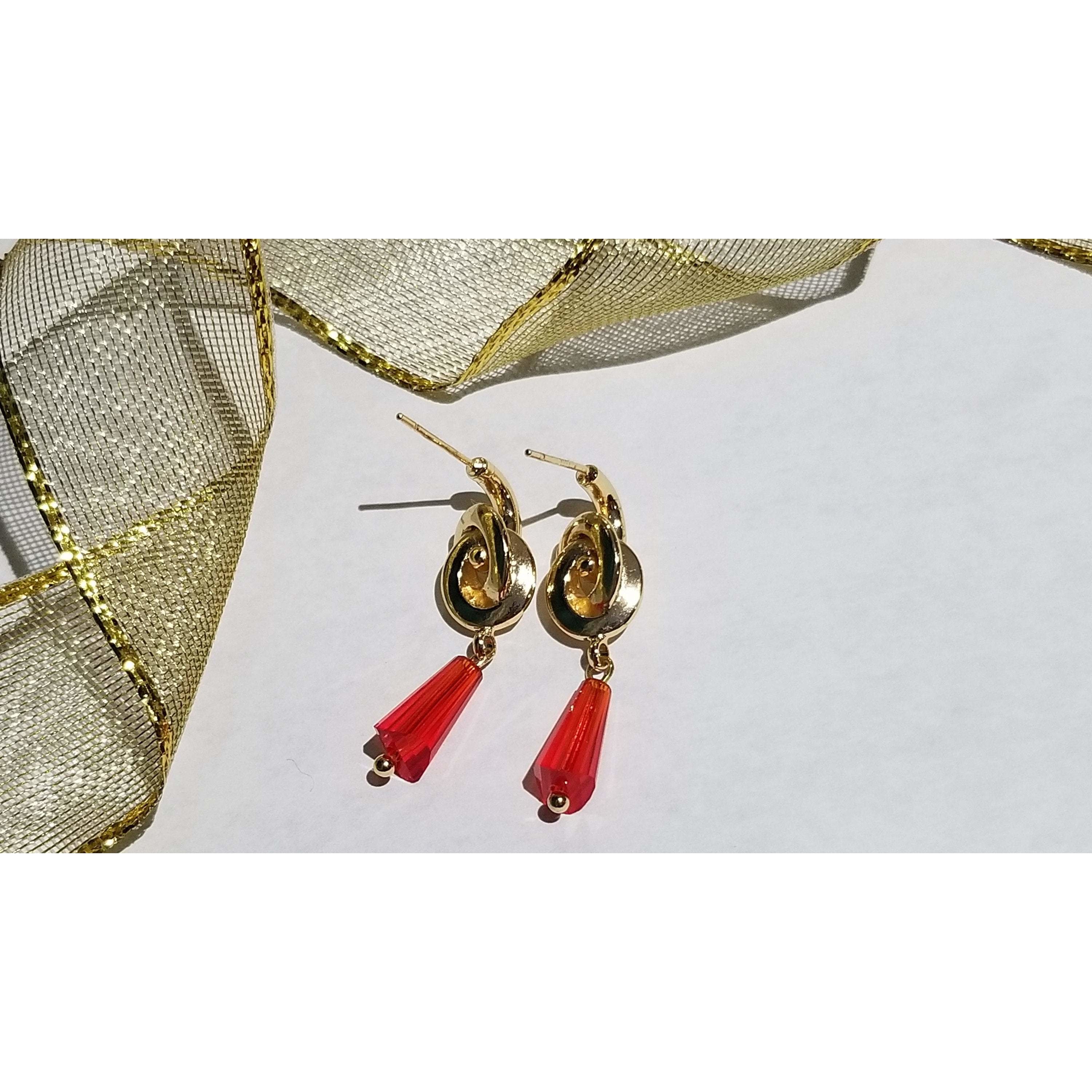 Elegant conical crystal beads on golden knot ear studs, showcasing a trendy brass design with a luxurious 24K gold color plating.