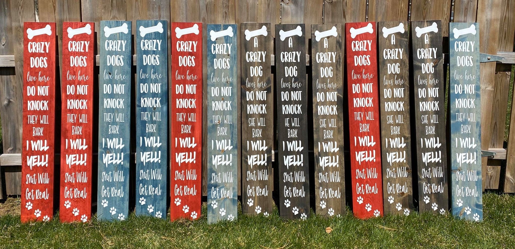 A humorous wooden front door sign that reads 'Crazy Dogs Live Here Do Not Knock They Will Bark I Will Yell Shit Will Get Real', showcasing unique wood grain.