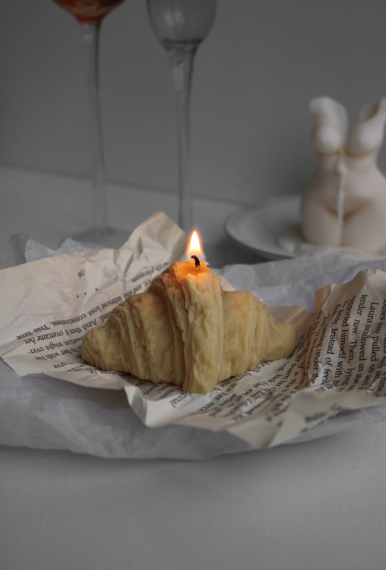 A beautifully crafted croissant-shaped candle made from soy wax blend, perfect for home decor.