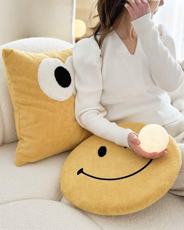 Cute whimsical decorative throw pillow with big eyes, made of soft milk velvet and filled with plush feather fibre, perfect for home decor.