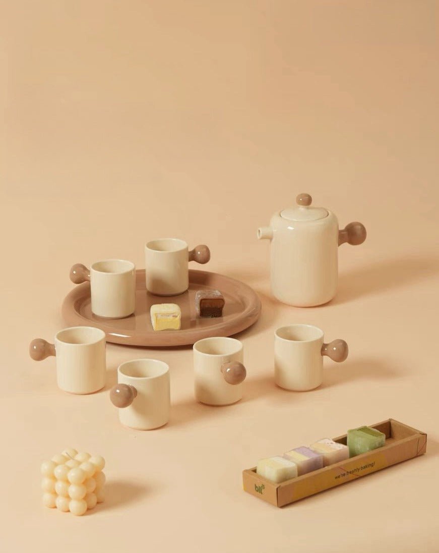 Cute Bauhaus inspired ceramic tea pot and tea cups set with vibrant dopamine colors, perfect for stylish tea gatherings.