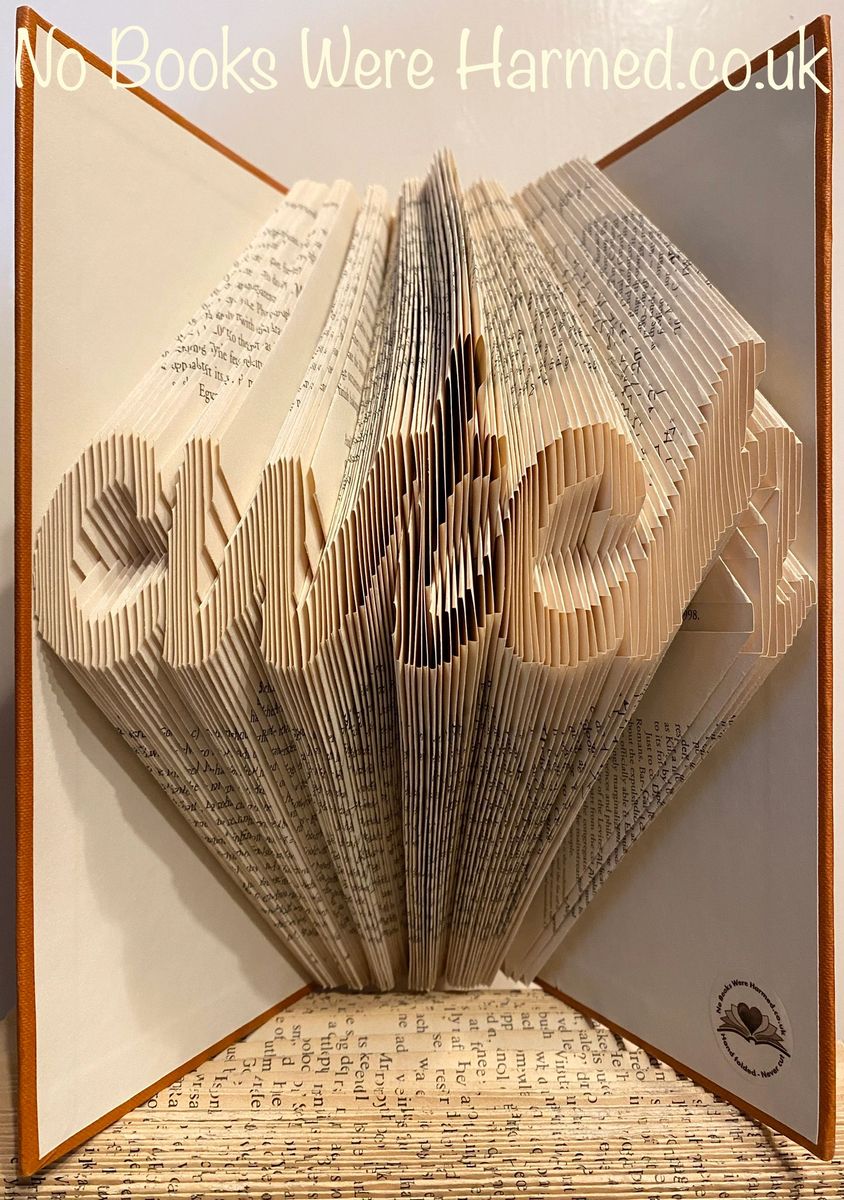 A handcrafted 'cwtch' art piece made from vintage book pages, showcasing intricate folds and unique design.