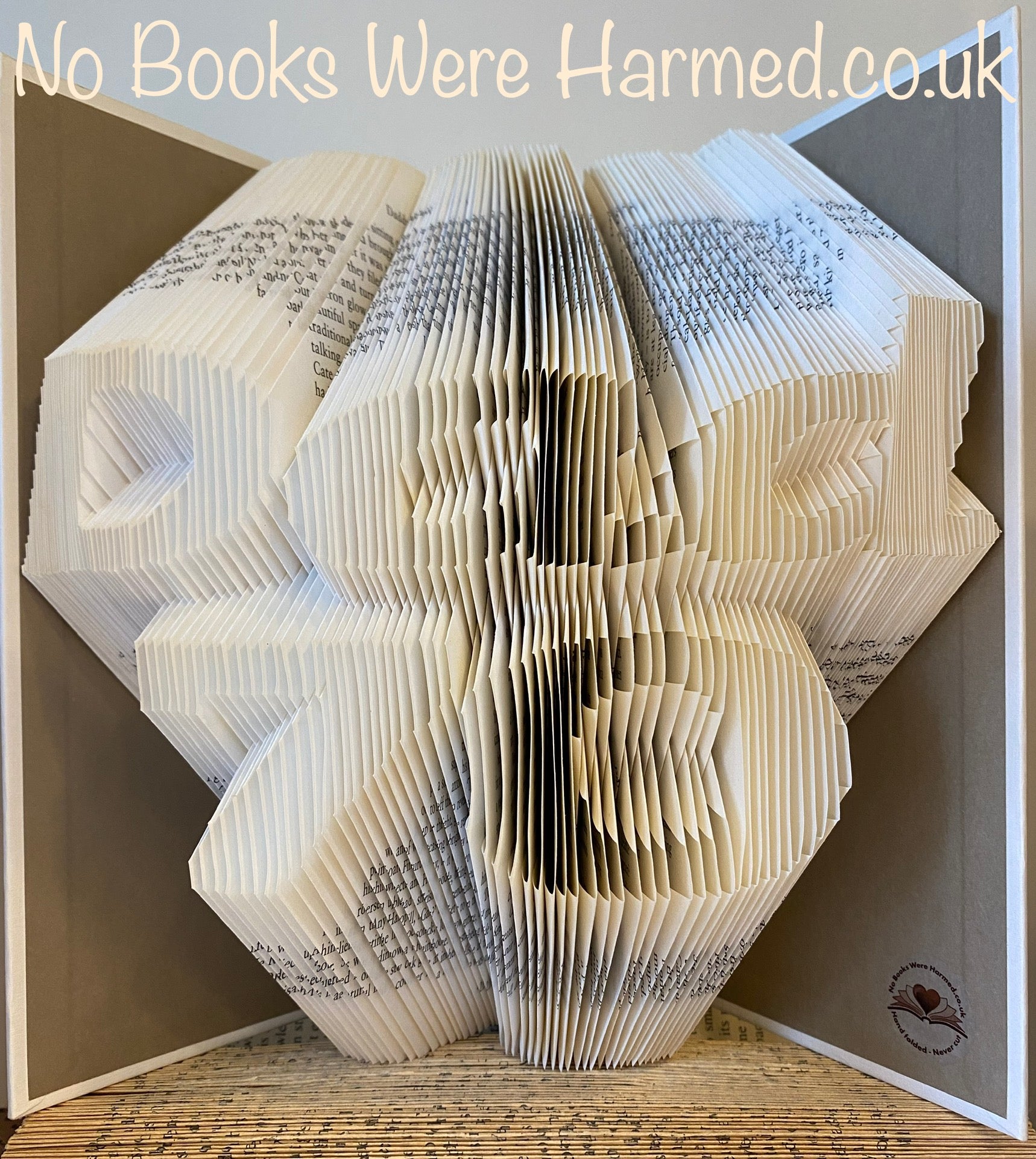 Handcrafted art piece featuring the word 'Dad' over a customizable number, made from vintage book pages, showcasing unique folds and colors.