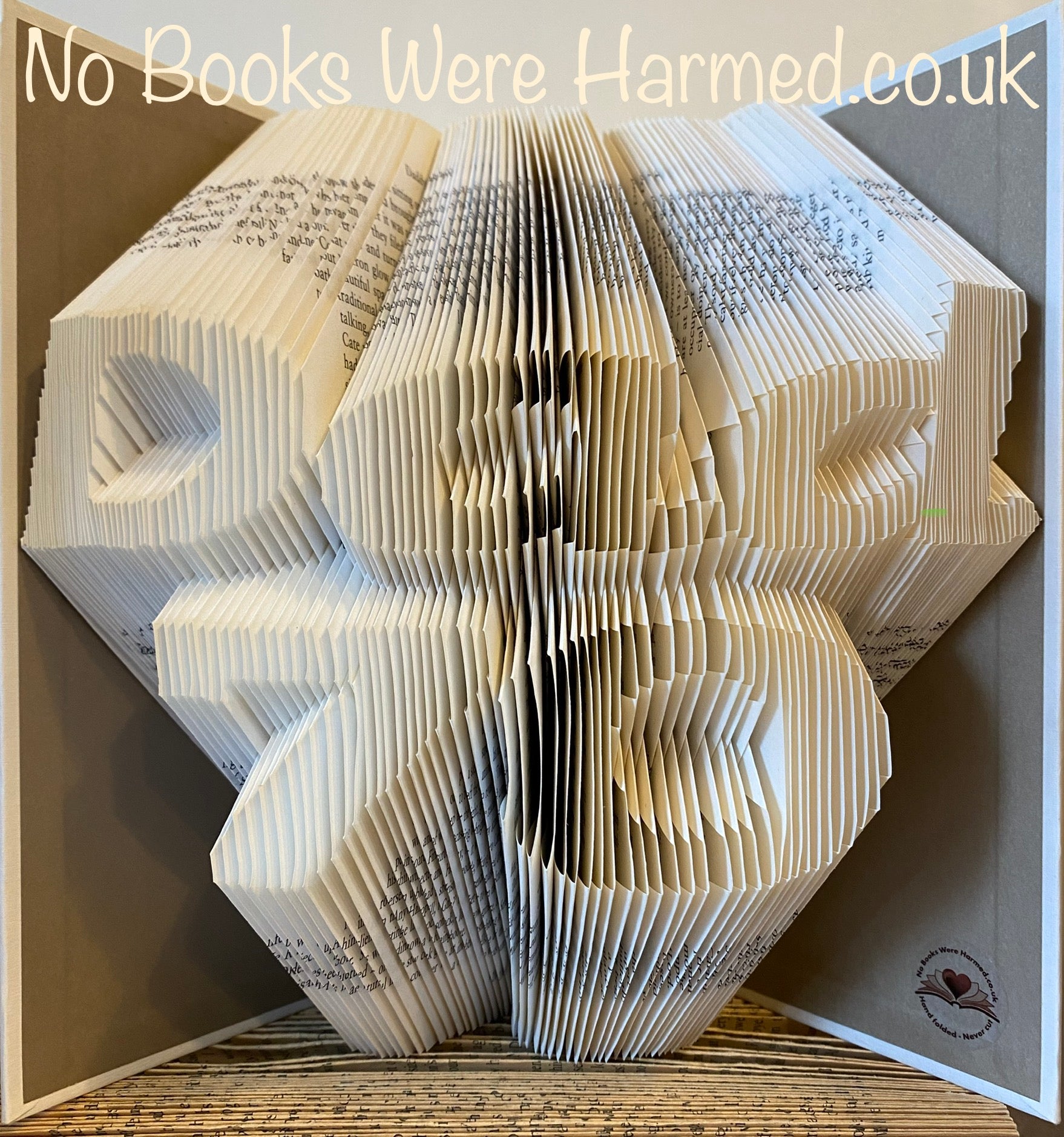 Handcrafted art piece featuring the word 'Dad' over a customizable number, made from vintage book pages, showcasing unique folds and colors.