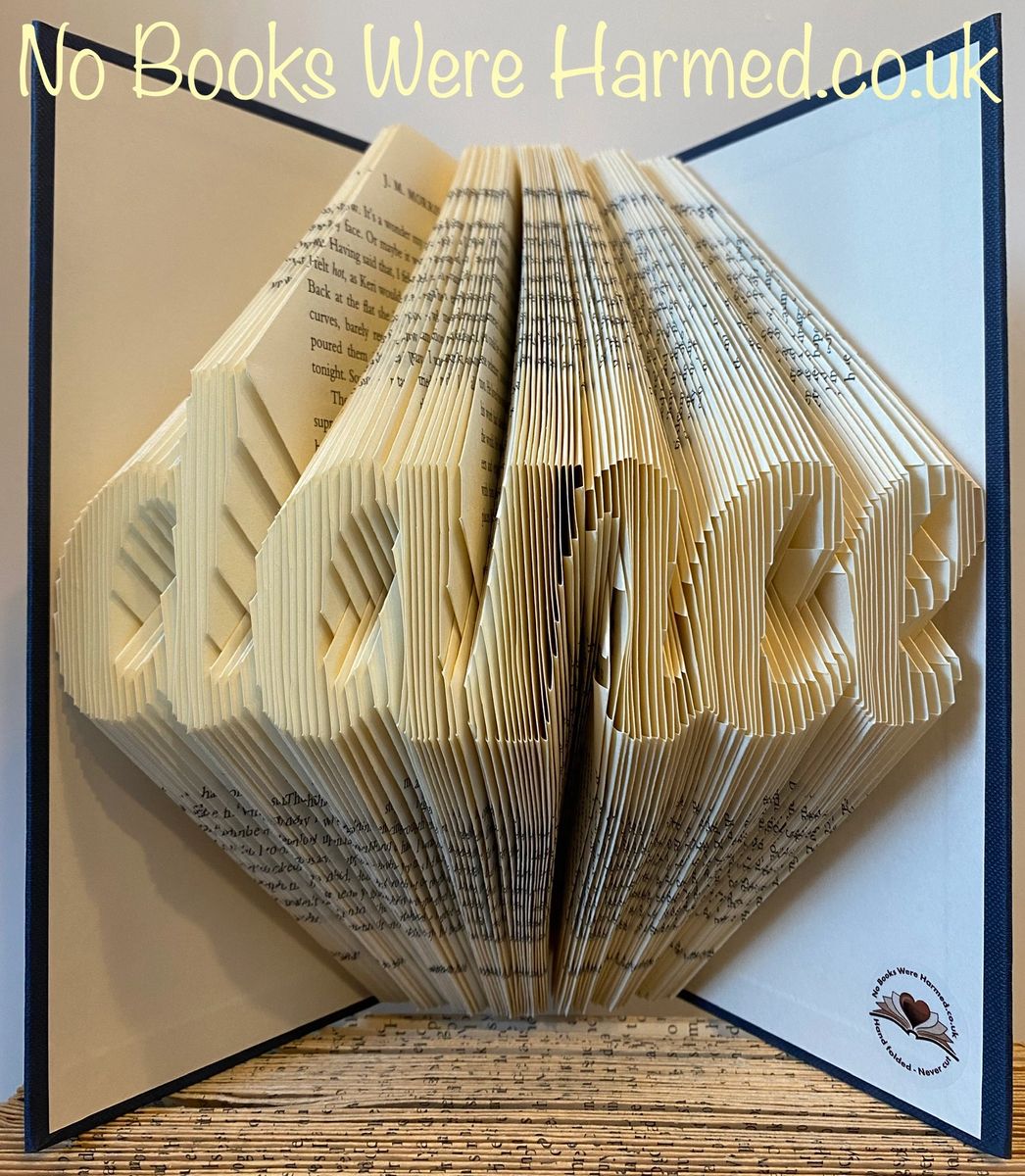 Handcrafted dance-themed book art made from vintage books, showcasing intricate hand-folded pages in various colors.