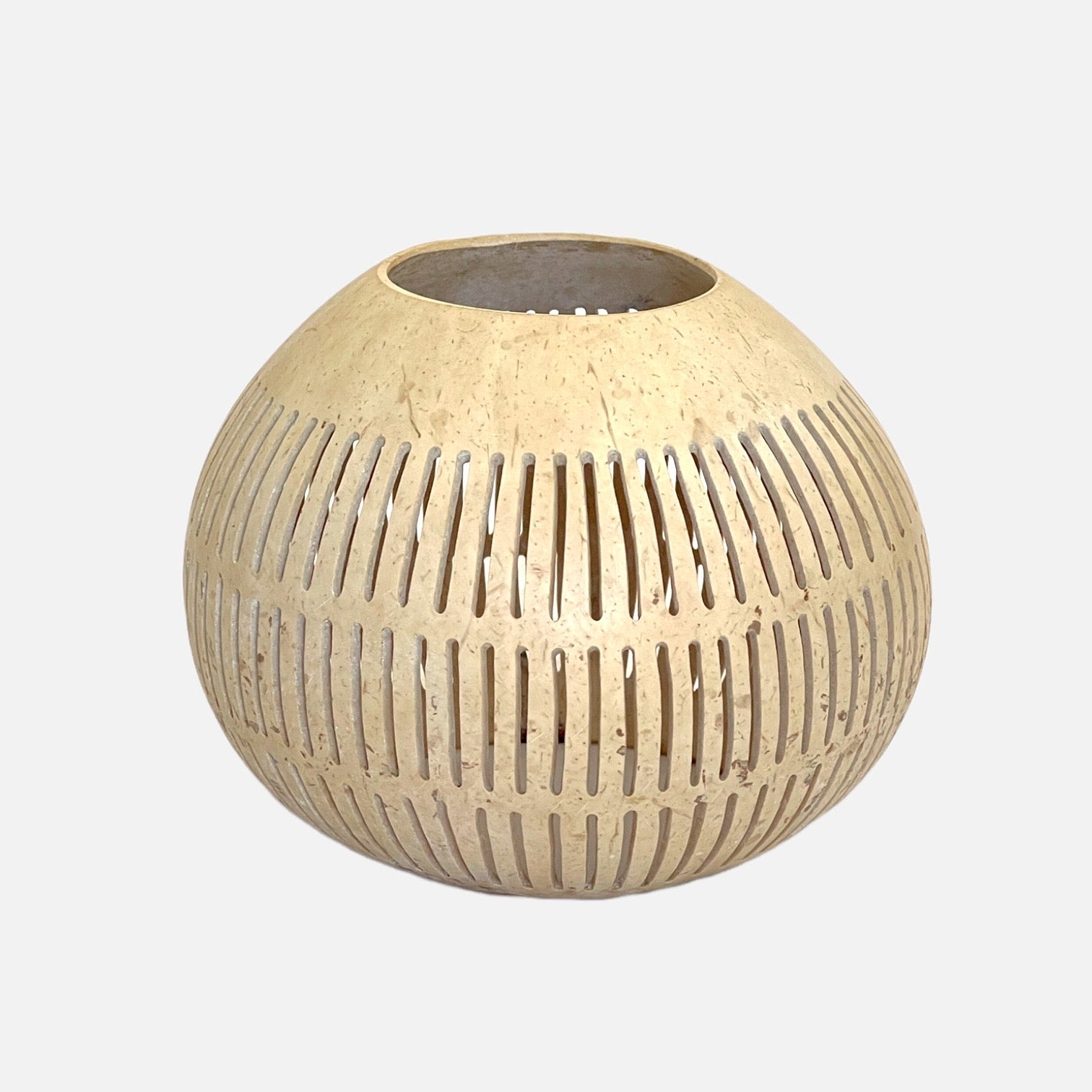 Decorative coconut decor piece with light color, used as a candle holder or tabletop accent.