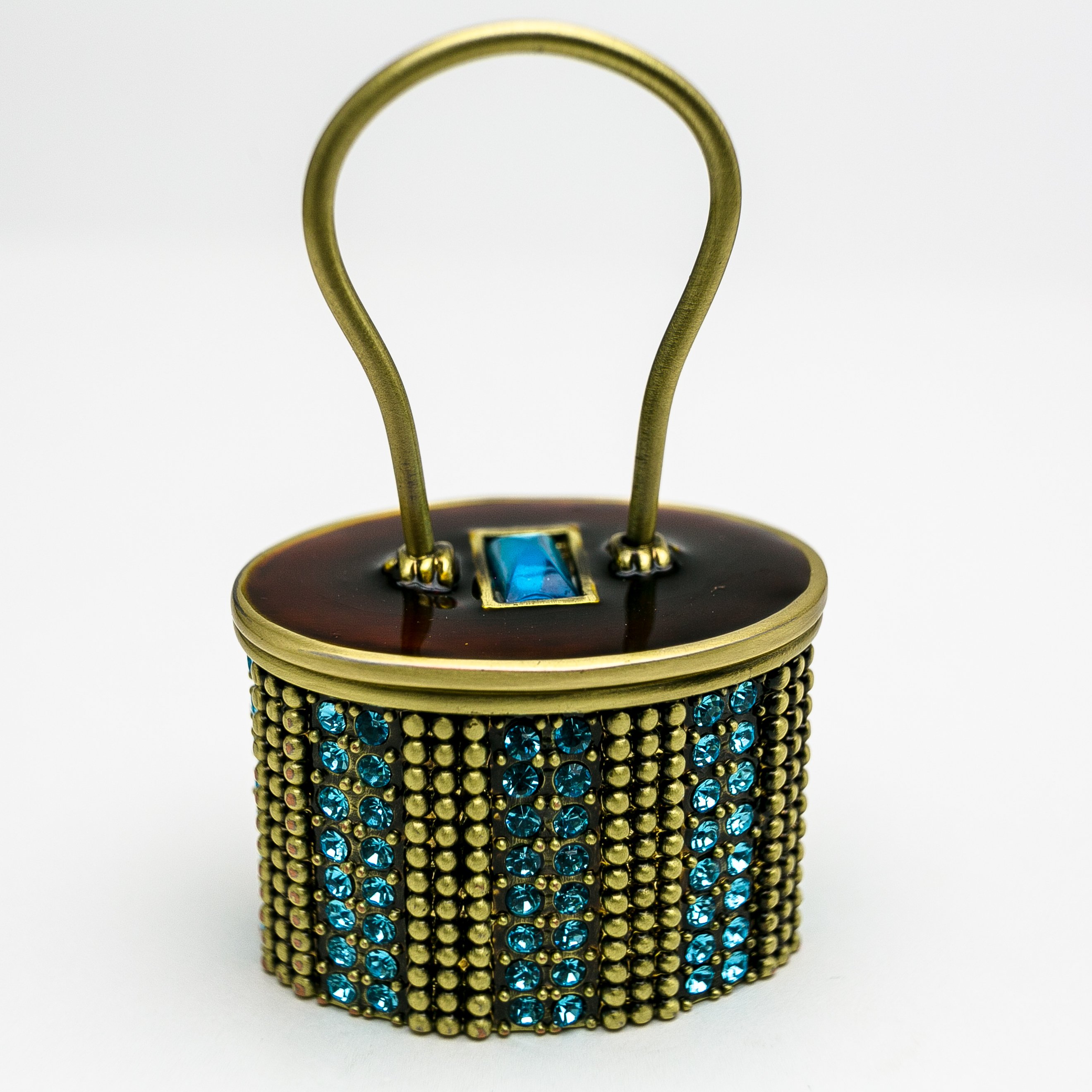 A beautifully decorated handbag featuring enamel painting and Austrian crystals, showcasing intricate craftsmanship and luxurious materials.