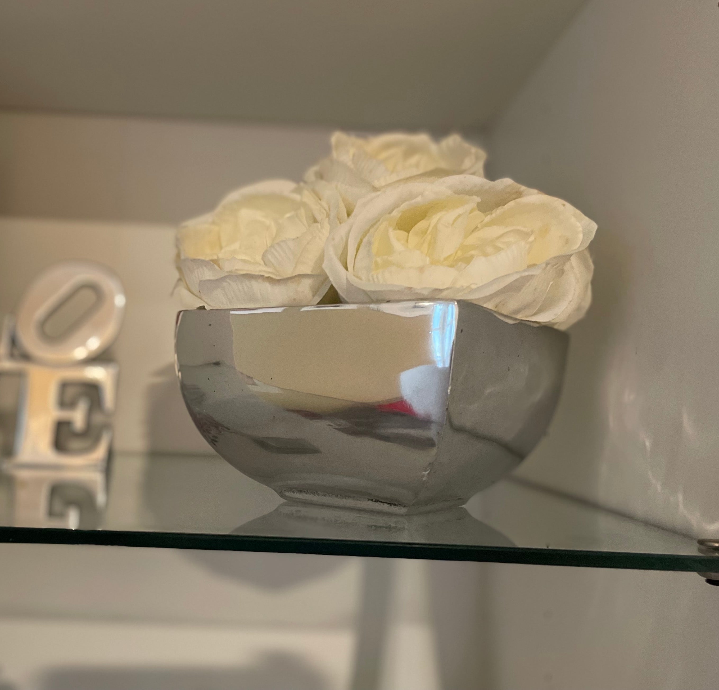 A sleek, minimalist decorative flower vase made from recycled aluminum alloy, showcasing a smooth finish and clean lines, perfect for various plants.