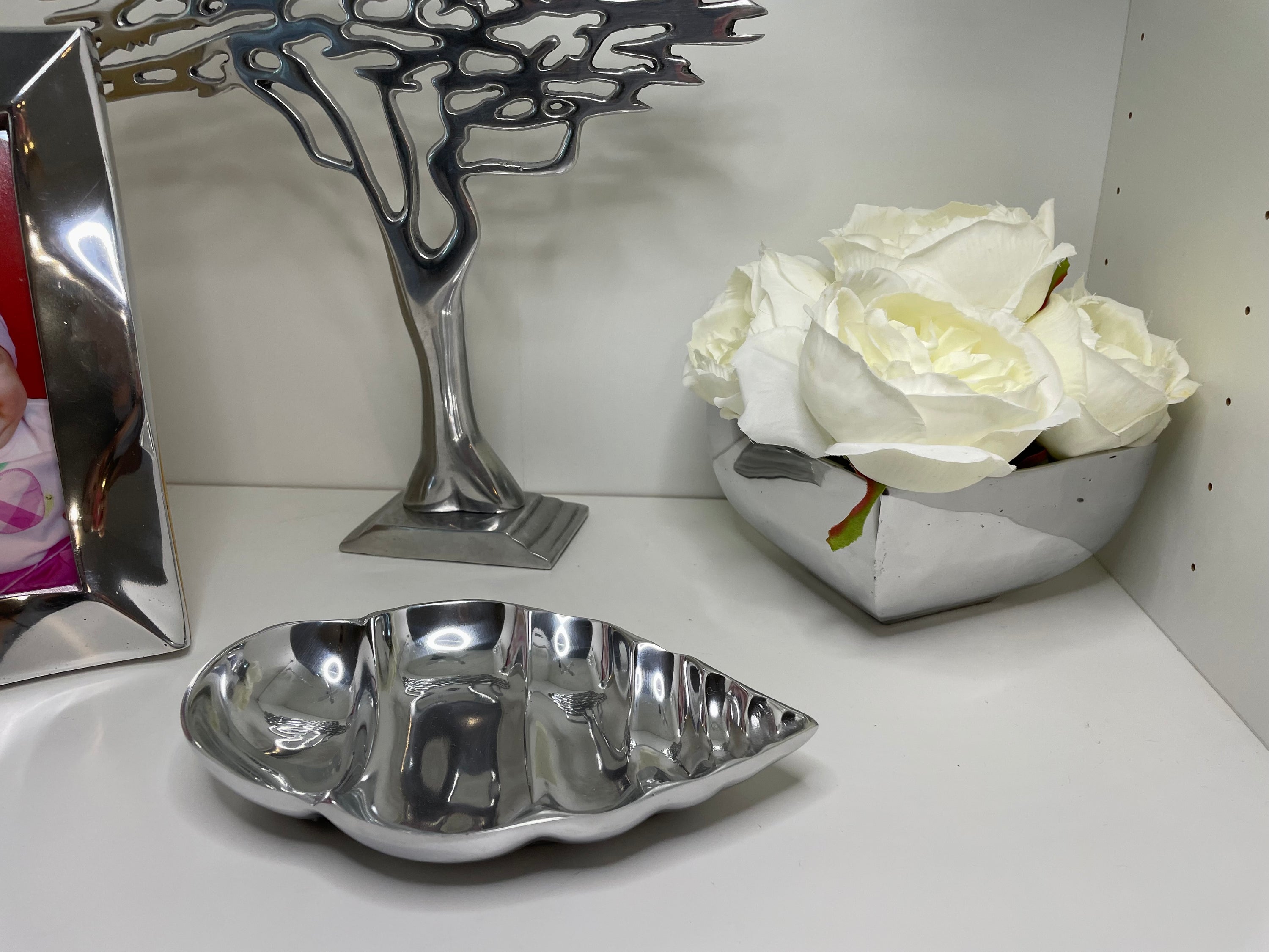 A sleek, minimalist decorative flower vase made from recycled aluminum alloy, showcasing a smooth finish and clean lines, perfect for various plants.