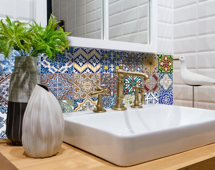 A colorful set of 24 decorative peel and stick tile stickers displayed on a smooth surface, showcasing various unique designs.