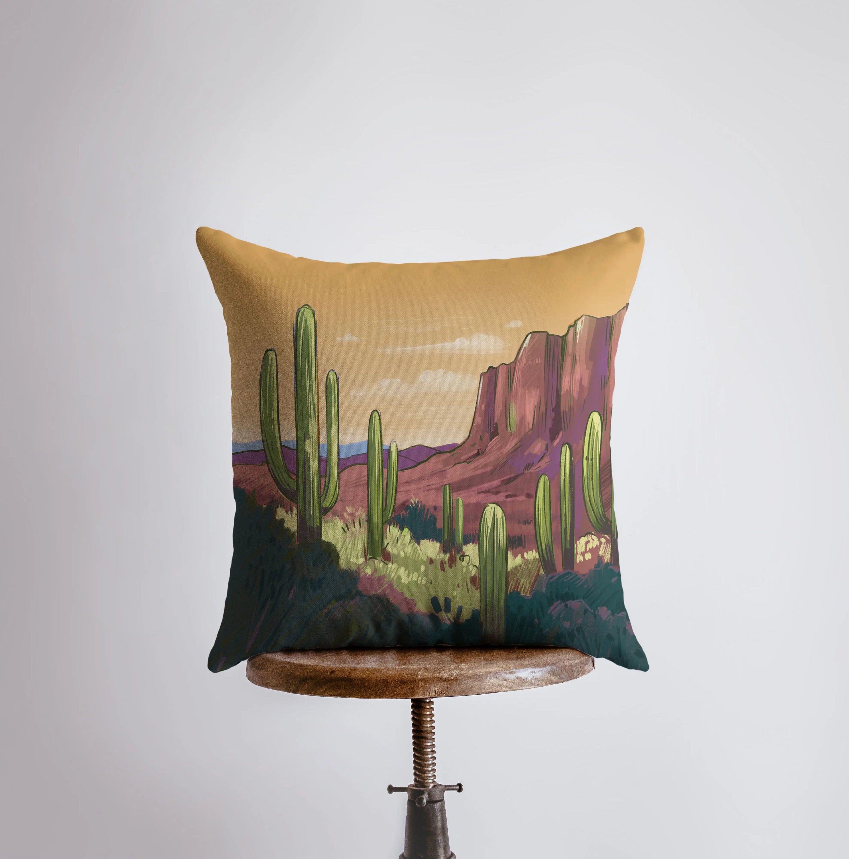 Arizona Sunrise and Purple Sunset pillow showcasing vibrant desert landscape art with cacti, featuring a double-sided design.