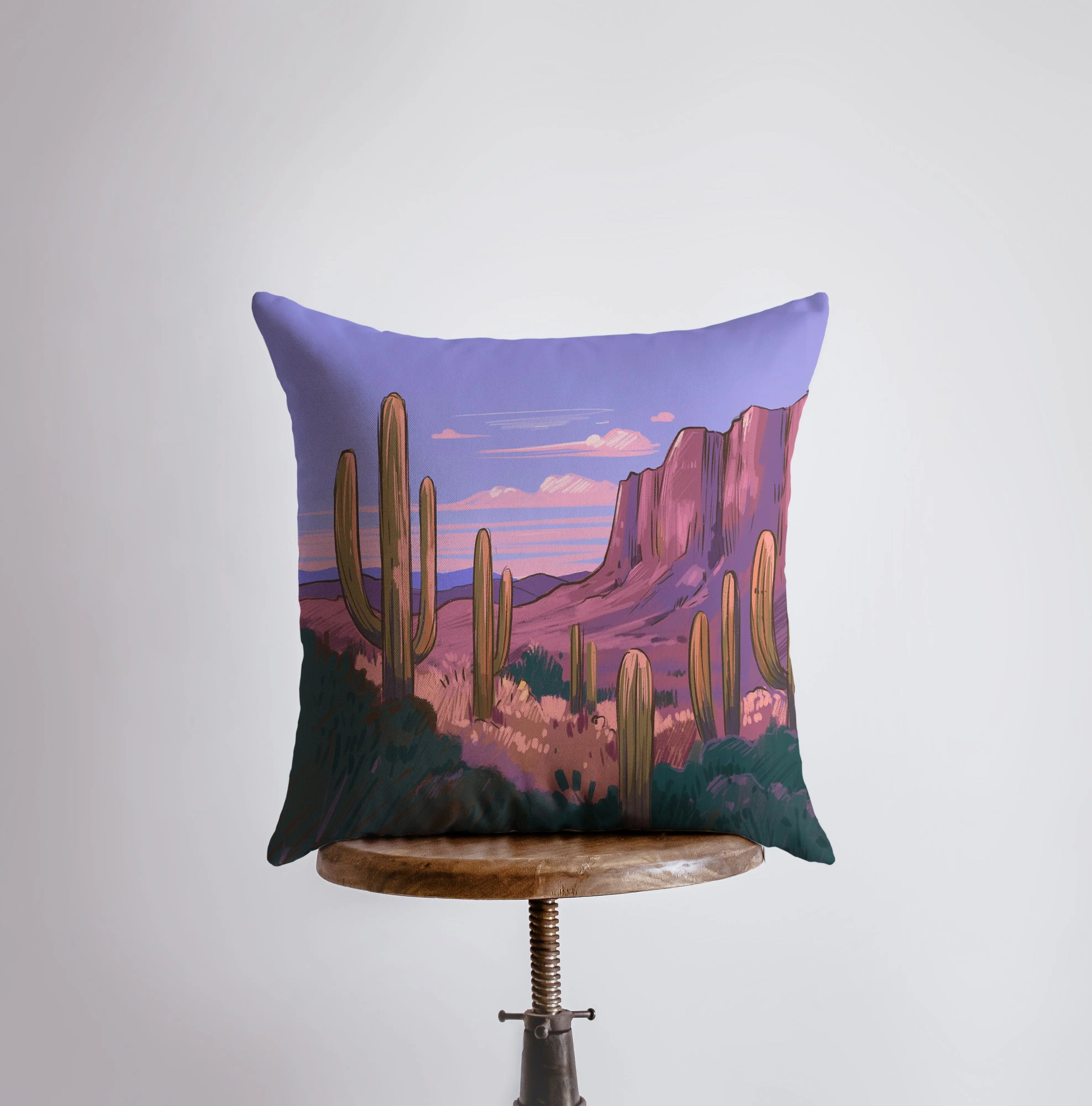 Arizona Sunrise and Purple Sunset pillow showcasing vibrant desert landscape art with cacti, featuring a double-sided design.