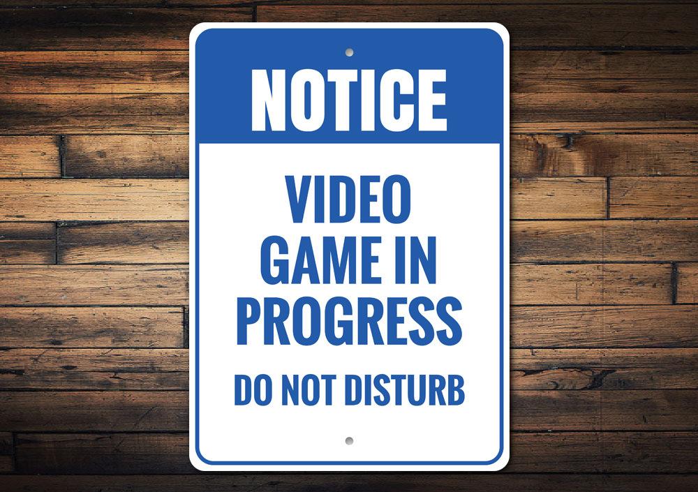 A decorative Do Not Disturb Video Game Sign made of aluminum, featuring vibrant colors and customizable text, perfect for gaming rooms.