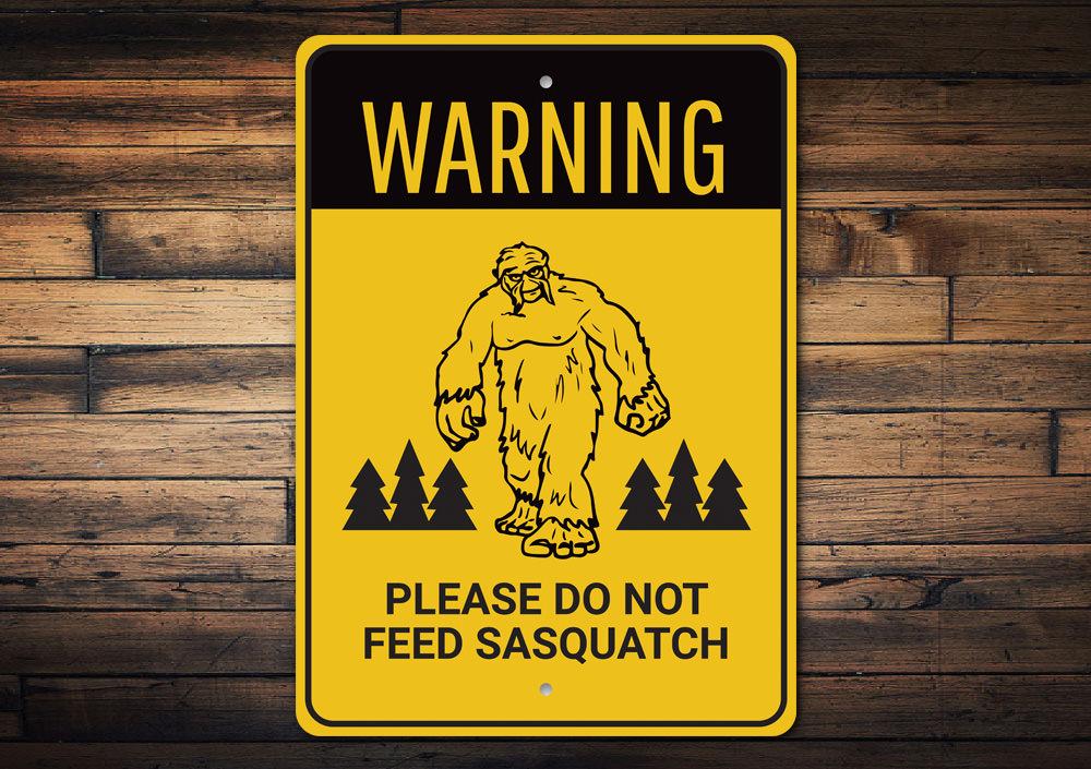 A humorous Do Not Feed Sasquatch Sign made of high-quality aluminum, featuring a playful design perfect for home decor.