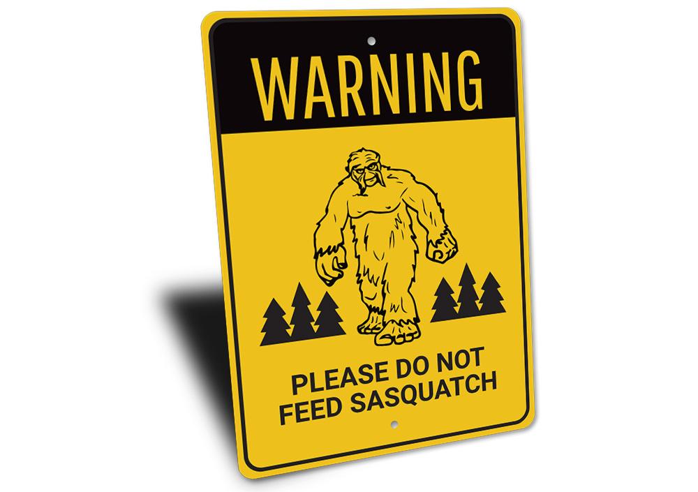 A humorous Do Not Feed Sasquatch Sign made of high-quality aluminum, featuring a playful design perfect for home decor.