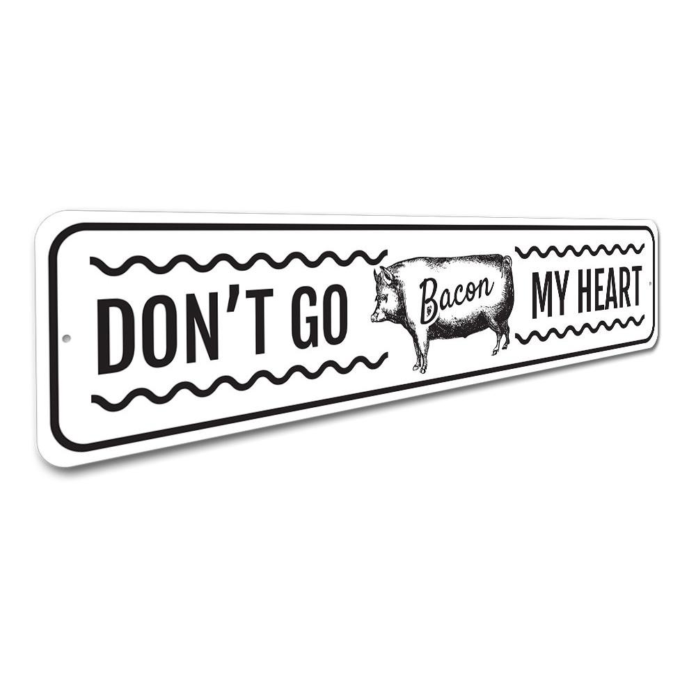 Don't Go Bacon My Heart metal sign featuring a humorous design, perfect for home decor.