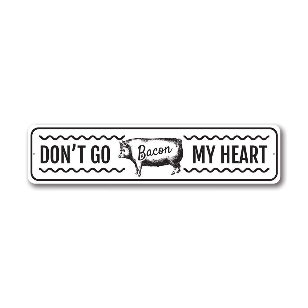 Don't Go Bacon My Heart metal sign featuring a humorous design, perfect for home decor.