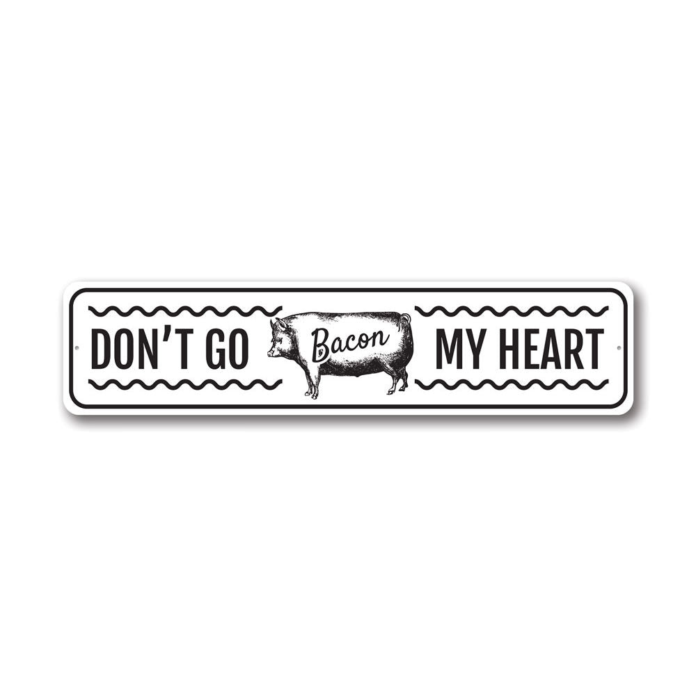 Don't Go Bacon My Heart metal sign featuring a humorous design, perfect for home decor.